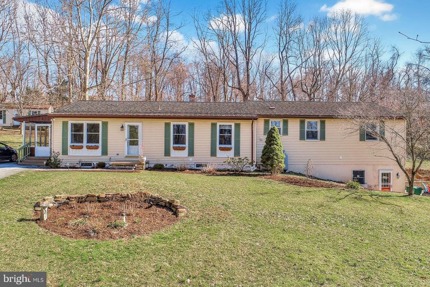 Come see this beautifully updated ranch situated on a 1.10 acre country lot, featuring a cook's kitchen with gas cooktop, granite counters, cork flooring, double ovens with convection, and updated appliances.  Brazilian chestnut floor in spacious living and dining rooms.  Wonderful master bedroom retreat with office and walk-in closet.  Office is plumbed for future master bath.  Convenient first floor laundry. The upgrades continue in the finished lower level, including a second kitchen, a remodeled bathroom with heated tile floor, 5th bedroom and a two sided gas fireplace in the family room and kitchen area. Enjoy this peaceful setting from the screened side porch and covered rear porch.  Ample parking with new stone retaining wall and oversized 2 car garage with storage closets. A detailed list of renovations is available. Possible in-law suite in lower level.