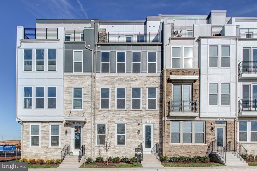 Commuter Friendly 4 Level Townhome. Walk to shops and Wegmans! Community Tot lot, trail, and pond. Upgraded Oak floors and staircases on all levels. Gourmet kitchen with Extended Luna Pearl Granite Island and Expresso Cabinets. Stainless steel appliances and Gas Cooktop designed for a chef.  Composite deck balcony off kitchen and dining. Recreation room with full bath and oversized two car garage. 3rd floor has two large bedrooms and full bath with dual vanity with granite.  Loft area for second family room pre-wired for entertainment. 4th level Master retreat with tray ceilings, walk in closet, 6 foot soaking tub, separate vanities, and large shower. Private Rooftop Terrace with Gas fireplace to gaze at the stars or read a book.