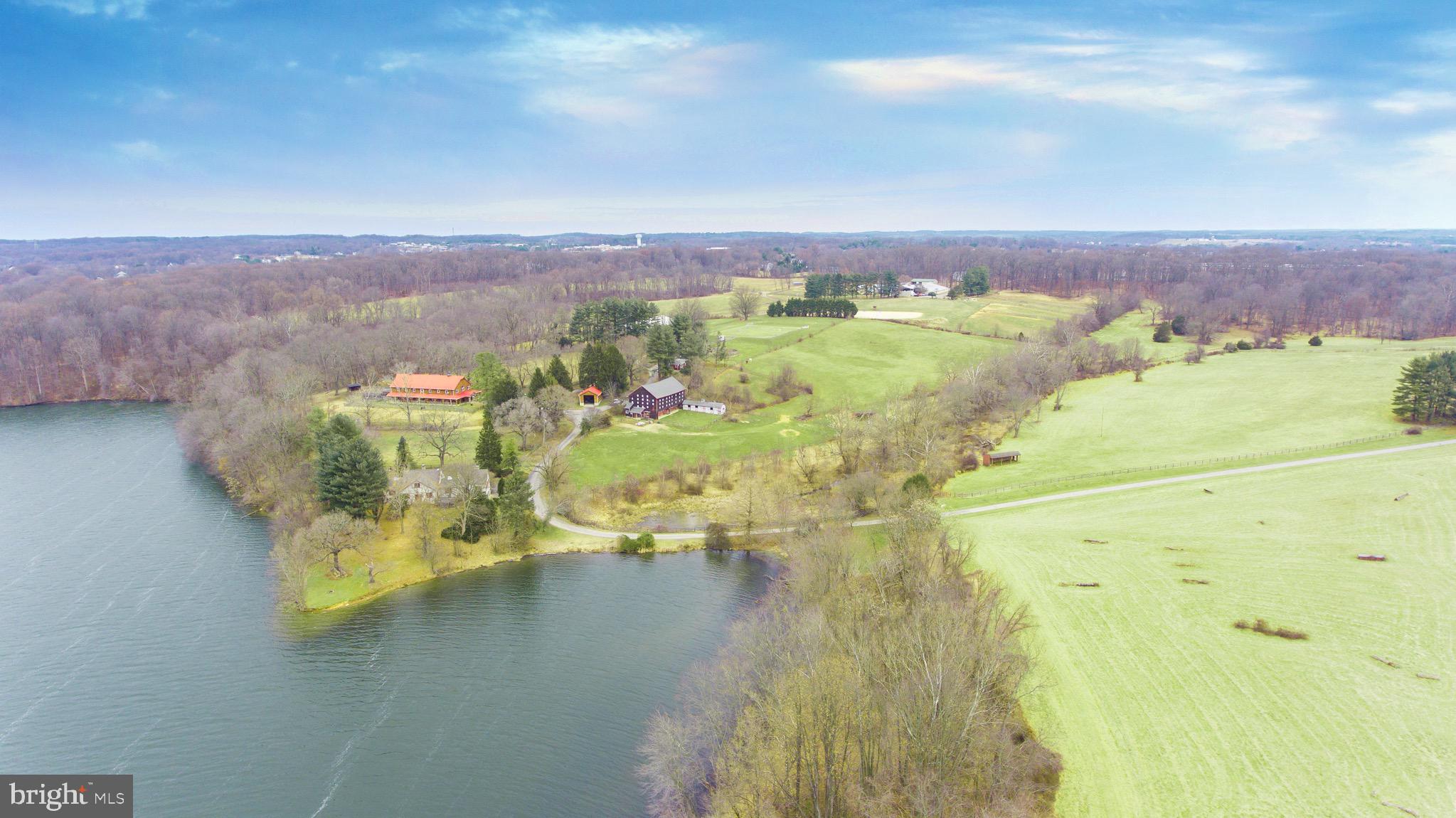 This magical waterfront estate is available for the first time in many years. Recently developed by the horseman, for the horseman yet also offers amenities for the non horse person in the family. The 63 acre property has over 2,000 feet of water frontage on Piney Run Reservoir commanding views form much of the property. The main home is situated on an elevated point and has water views from three sides. Multiple locations on the property offer peaceful water views. This one of a kind property could be a private estate home or be considered for many agricultural business opportunities. Be truly on vacation while at home. Historic Legacy Farm, State-of-the-Art Equestrian Facility with multiple board fenced lush pastures. Secluded Location adjacent to miles of trails. State-of-the art B & D Builders 12 Stall Barn with 2 heated tack rooms, hot water wash stall with heat lamps, plus multiple offices, lounges, training rooms, kitchenettes, deck, 2 full bathrooms and expansive, well appointed quarters over the barn. 11 Stall Bank Barn/shed row with tack room and wash stall. 70'x 200' Indoor arena with rubber/fiber/sand footing and 150'x 200' Outdoor arena with all weather footing. Round Pen for training. Beginner Novice thru Prelim Cross Country Training Area. Tractor/ Storage Sheds for equipment, hay and shavings. Separate 3 bedroom tenant house. Lakeview Main House with remodeled kitchen, fabulous Great Room, recent roof and custom garage doors. With a history woven from World War II, Europe and classical riding through to the importation and evolution of the sport of modern dressage in the United States, from an eminent breeding facility of horses and ponies, plus immersion in the heyday of the MHSA in the 1950s and 1960s, touching on U.S. presidents in the 1980s, introducing this country to the beauty of the Baroque horse and a revival of classical horsemanship, eventually becoming a top-tier East Coast eventing training facility, with every conceivable modern amenity. Located in the heart of Central Maryland horse country, with easy access to national and international transportation corridors, this premiere property is destined to continue its premiere equestrian heritage under a new owner. Property is subject to a conservation easement granted to the Maryland Environmental Trust.