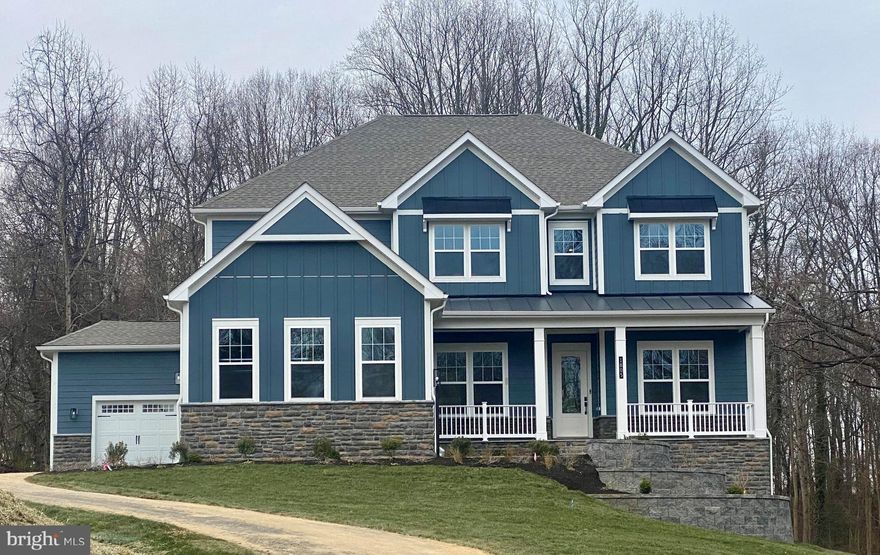 Celebrate a new year in a new home! 
Luxury meets comfort in this stunning home currently under construction in Davidsonville with an estimated January completion date.  This 6-bedrooom, 5.5 bathroom residence with a 4-car garage offers an ideal blend of sophisticated design, spacious living, and modern convenience.  Every detail of the Stonehaven floor plan is thoughtfully crafted to provide both style and functionality for today’s lifestyle.  A welcoming porch with slate greets upon entry with gorgeous stone and hardie plank exterior.  The open concept floorplan with soaring 10 ft. Ceilings and abundant natural light creates an abundance of natural light creates a warm and inviting atmosphere.  A formal dining room with tray ceiling is opposite of the study at the entry.  For convenience, a butler pantry w/ beverage cooler is located off the dining room leading to the kitchen.  The kitchen/family room area includes a highly desirable open-concept feel and includes a tray beamed ceiling.  A cozy 60” Crave gas fireplace is included in the family room.  Double glass sliding doors provide a gorgeous, wooded view of the outdoors.  Our Pro-Kitchen is included with commercial-grade Kitchen-Aid appliances to include a slide-in gas range, built-in refrigerator, dishwasher, and microwave oven combo.  The two-toned kitchen is finished with Aristokraft soft-close white cabinets with an accented gray over-sized kitchen island.  Cabinets extend to the ceiling with glass display doors and lighting.  An abundance of storage is provided with the walk-in pantry conveniently located off the owner entry from the garage.  A drop zone with cabinets provides additional storage.  A main level bedroom ensuite is at the owner entry as well and includes a full bath and walk-in closet perfect for multi-generation living.  The 4-car garage is a garage lover’s dream with ample parking and storage for vehicles, hobbies, or a home workshop.  Durable Revwood floors are throughout the main living area.  A grand oak staircase with metal balusters is centrally located.  4 bedrooms, a loft, and laundry room complete the upper level.  The primary suite is a private retreat with spa-like ensuite bath with free-standing tub and walk-in shower with doors and transoms.  Overhead rain shower heads, handheld shower, and central shower heads finish this incredible bathroom.  Dual comfort height vanities are included with quartz counters.  No need to share space since this bedroom has 2 separate walk-in closets.  Both the primary bedroom and primary bath include tray ceilings.  All secondary rooms are sizeable and attached to a bath.  All bedrooms include a ceiling fan rough-in.  All secondary baths are finished with designer selected ceramic tile and quartz counters. A bedroom level loft completes the second floor.  For convenience, the basement is finished with a sizeable recreation room, bedroom, and full bath.  Sunlight will into the basement as it is a partial walk-out homesite with 9-foot ceiling height.  Stay connected to your home while away with included smart home technology which includes a skybell, zwave thermostat, wifi enabled garage door opener, and Deako smart switches.  Davidsonville is known for luxury estate homes, award-winning schools and forest conservation. The Stonehaven II is designed for our modern lifestyles and will be the perfect new home for you.