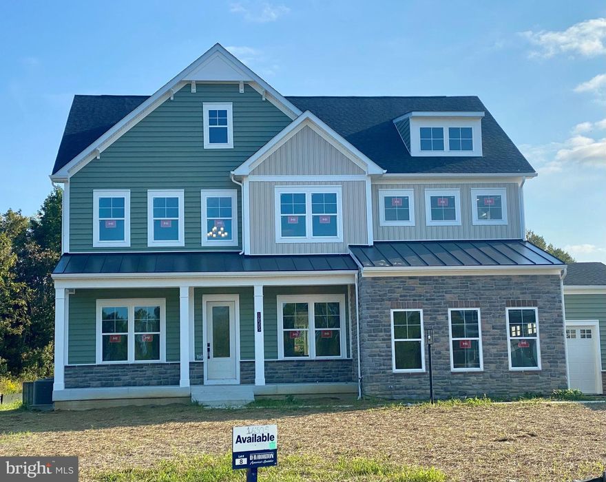 Celebrate a new year in a new home! 
Luxury meets comfort in this stunning home currently under construction in Davidsonville with an estimated January completion date.  This 6-bedrooom, 5.5 bathroom residence with a 4-car garage offers an ideal blend of sophisticated design, spacious living, and modern convenience.  Every detail of the Stonehaven floor plan is thoughtfully crafted to provide both style and functionality for today’s lifestyle.  A welcoming porch with slate greets upon entry with gorgeous stone and hardie plank exterior.  The open concept floorplan with soaring 10 ft. Ceilings and abundant natural light creates an abundance of natural light creates a warm and inviting atmosphere.  A formal dining room with tray ceiling is opposite of the study at the entry.  For convenience, a butler pantry w/ beverage cooler is located off the dining room leading to the kitchen.  The kitchen/family room area includes a highly desirable open-concept feel and includes a tray beamed ceiling.  A cozy 60” Crave gas fireplace is included in the family room.  Double glass sliding doors provide a gorgeous, wooded view of the outdoors.  Our Pro-Kitchen is included with commercial-grade Kitchen-Aid appliances to include a slide-in gas range, built-in refrigerator, dishwasher, and microwave oven combo.  The two-toned kitchen is finished with Aristokraft soft-close white cabinets with an accented gray over-sized kitchen island.  Cabinets extend to the ceiling with glass display doors and lighting.  An abundance of storage is provided with the walk-in pantry conveniently located off the owner entry from the garage.  A drop zone with cabinets provides additional storage.  A main level bedroom ensuite is at the owner entry as well and includes a full bath and walk-in closet perfect for multi-generation living.  The 4-car garage is a garage lover’s dream with ample parking and storage for vehicles, hobbies, or a home workshop.  Durable Revwood floors are throughout the main living area.  A grand oak staircase with metal balusters is centrally located.  4 bedrooms, a loft, and laundry room complete the upper level.  The primary suite is a private retreat with spa-like ensuite bath with free-standing tub and walk-in shower with doors and transoms.  Overhead rain shower heads, handheld shower, and central shower heads finish this incredible bathroom.  Dual comfort height vanities are included with quartz counters.  No need to share space since this bedroom has 2 separate walk-in closets.  Both the primary bedroom and primary bath include tray ceilings.  All secondary rooms are sizeable and attached to a bath.  All bedrooms include a ceiling fan rough-in.  All secondary baths are finished with designer selected ceramic tile and quartz counters. A bedroom level loft completes the second floor.  For convenience, the basement is finished with a sizeable recreation room, bedroom, and full bath.  Sunlight will into the basement as it is a partial walk-out homesite with 9-foot ceiling height.  Stay connected to your home while away with included smart home technology which includes a skybell, zwave thermostat, wifi enabled garage door opener, and Deako smart switches.  Davidsonville is known for luxury estate homes, award-winning schools and forest conservation. The Stonehaven II is designed for our modern lifestyles and will be the perfect new home for you.