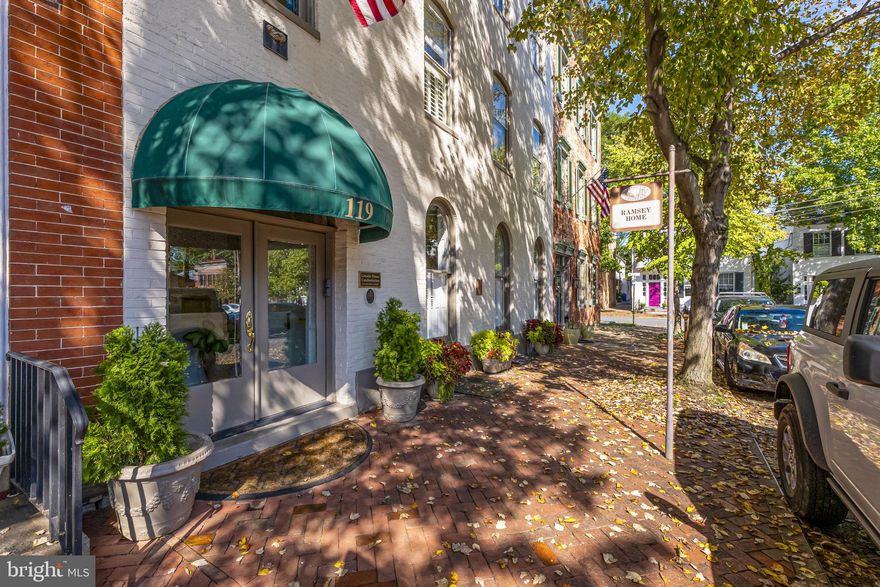 The Lincoln House condominiums is so named as the site of a meeting between President Lincoln and General Hartsuff during the Civil War. This 3 unit condominium building offers a secured entry, and gated parking area with garages. This main level home offers 2384 square feet of luxury living featuring high ceilings, large windows thru out, original fireplace mantels, architectural details, and original flooring all combined with the best in modern amenities. Enter into a huge Great Room with fireplace and original mantel, opening to gourmet eat-in kitchen also with fireplace and access to outdoor patio dining/grilling area. This home offers 3 BR, 2 baths including a primary suite with spa bath and walk-in custom closet. There is also a solarium with tile floors and a wall of windows with garden views, a private screened porch, laundry with washer and dryer, mudroom with access to gardens and secure gated garage parking. Located on historic Court Square, just 2 blocks to restaurants, and 1/2 block to Baker Park. Rarely is one of these offered for sale.