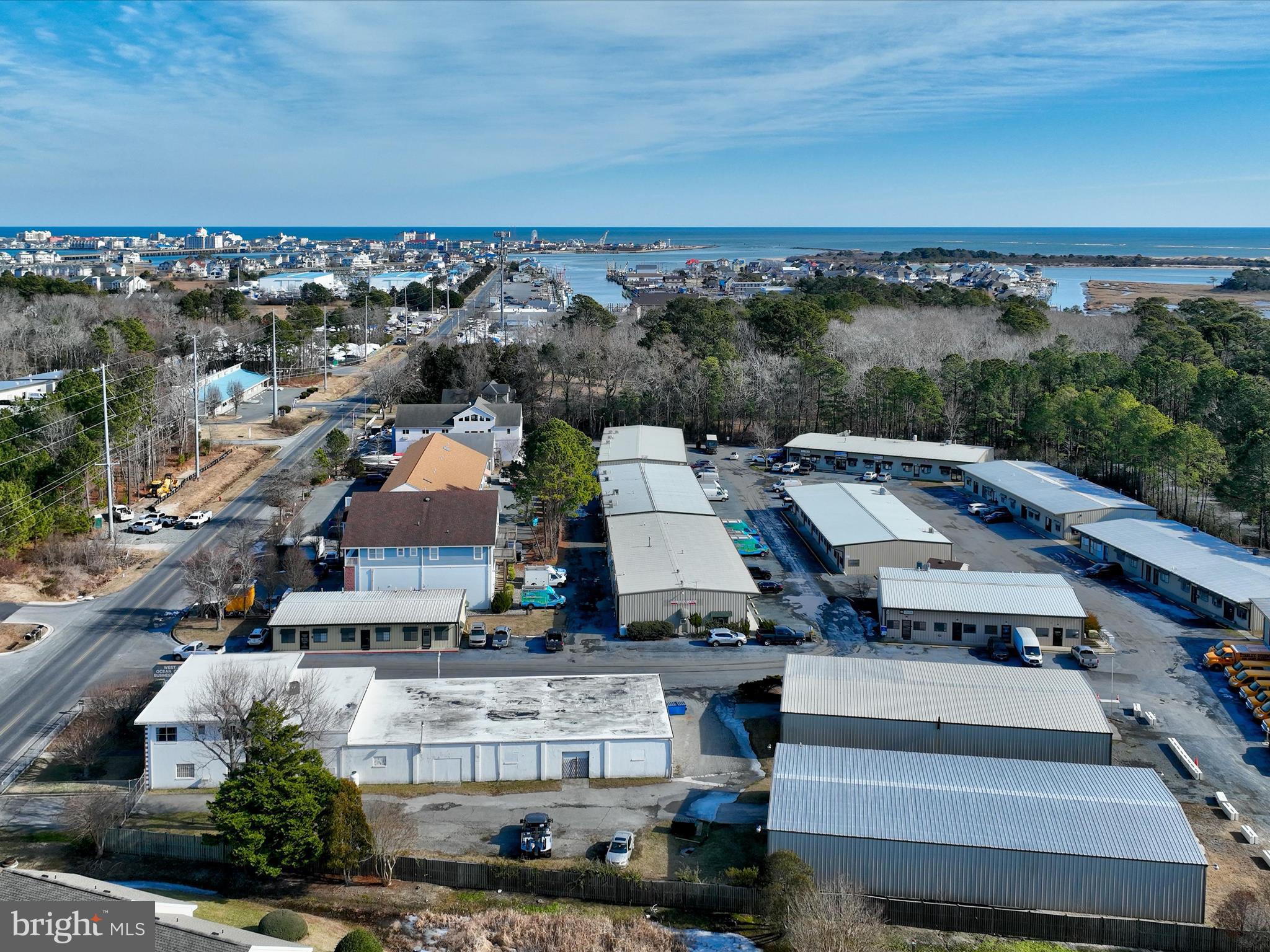 Price recently adjusted! A unique mixed-use property with a prime location in West Ocean City situated on a 1-acre, commercial C-2 zoned site with 95 feet of frontage on Sunset Ave. The property as a whole offers 2 offices, 2 warehouses, a 2nd floor 3 bedroom/1.5 bath apartment, and a side yard. Unit 1 encompasses 2 separate office units, a warehouse and the 2nd floor apartment. The two separate offices with separate entrances off covered foyer are approximately 1,500 total square feet of office space. The warehouse located behind in Unit 1 offers approximately 6,040 sq ft. The apartment is approximately 1500 square feet and the kitchen was renovated in '23. The offices each offer their own restroom, and the warehouse also has its own restroom as well as multiple warehouse access points and roll up doors. Unit 3 offers a large 5,050 sq feet corrugated metal warehouse with electric throughout and multiple roll-up doors with 20’ ceiling height and a restroom. The property is on private well and public sewer. The apartment offers a water treatment system and an updated heating system. There is a generator powered by an above ground propane tank. The property conveys with two EDU’s. The sale includes two units of a three unit condominium complex. Units 1 & 3 are included in this sale and the condo association does not collect dues at the current time. There are two owners, seller of 1 & 3, and the owner of unit 2, within the condo association and they handle their own insurances and expenses. See additional property marketing info in documents.