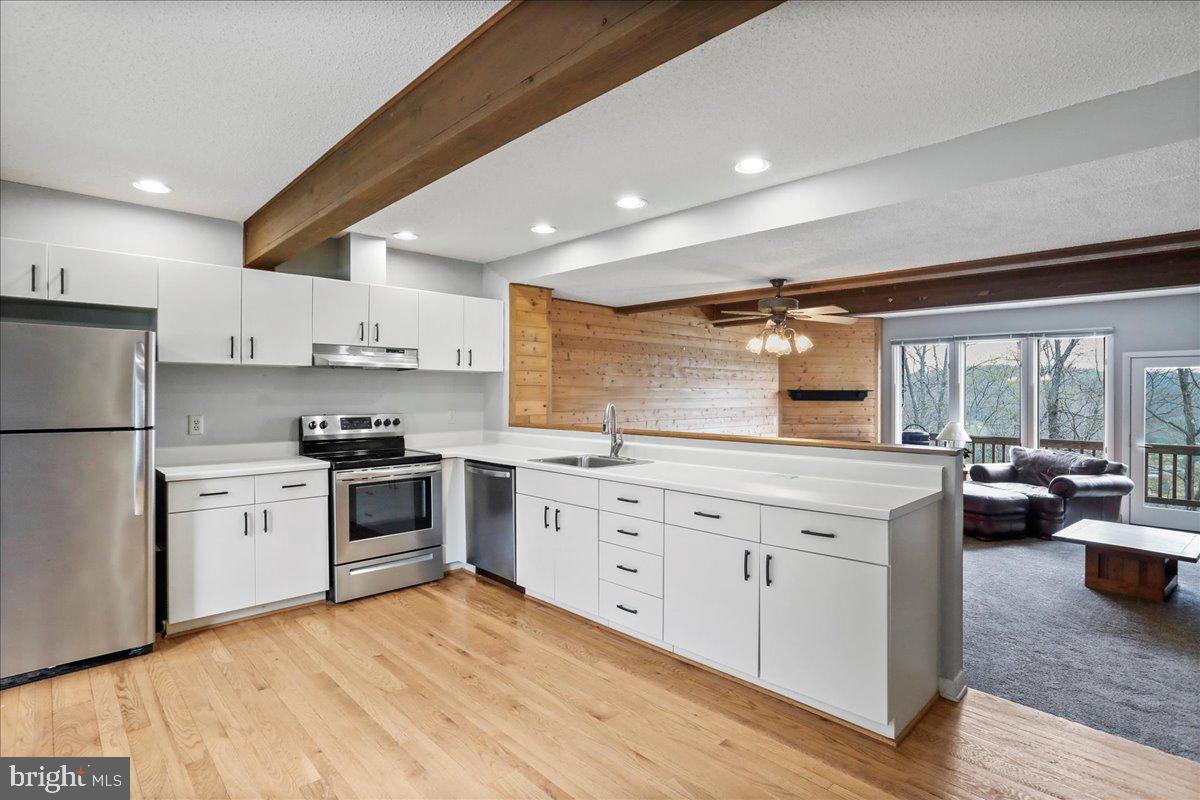 Whether you're searching for a cozy mountain escape or a turn-key rental investment, this fully furnished, ski-in/ski-out townhome at the Villages of Wisp offers it all—lake access, winter water views from all four levels of this home, and a location that puts every Deep Creek adventure right at your doorstep.
This home is not an active short-term rental, but in the community, these homes typically average $265 nightly and approximately $ 33,000 in gross rental income annually.
Freshly updated and move-in ready, the seller has just completed a round of renovations including fresh interior paint, updated light fixtures, exterior power washing, and other thoughtful touches to make this home feel bright, welcoming, and well cared for.
Spanning four levels, the home features the largest floorplan in the community with three bedrooms including a versatile loft that serves perfectly as a sleeping or entertainment space, and a finished lower level that works as a second living room, guest area, or additional bedroom—making it ideal for hosting or maximizing rental capacity.
After a day on the slopes or trails, relax in your private hot tub or gather around the wood-burning fireplace for a cozy evening in. Enjoy peaceful winter views of the lake from the comfort of home, and when warmer weather arrives, take advantage of the private lake access with a gazebo, pavilion, picnic area, and day-use docks for swimming, paddling, or just soaking up the sun.
Located just minutes from shopping, dining, state parks, and golf courses, this home offers the flexibility and comfort today’s buyers are looking for—whether you're building family memories or your short-term rental portfolio.
Homes in this location don’t come along often—schedule your private tour today and make this fully furnished Deep Creek retreat yours! Homes in this community have an average gross rental income of $25k to $30k annually.