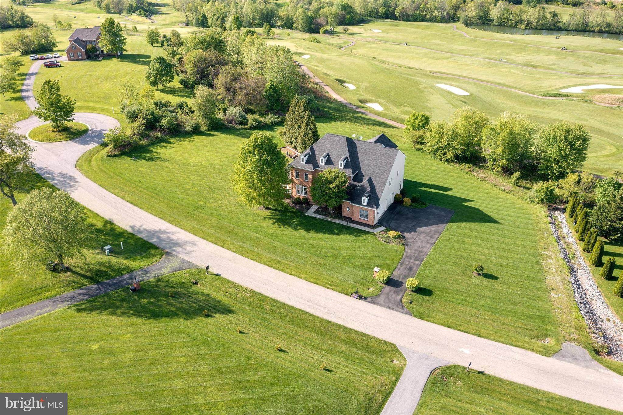Experience refined comfort and effortless elegance in this expansive residence, perfectly positioned with panoramic views of the rolling fairways and manicured greens of the neighboring golf course. This home blends formal sophistication with relaxed everyday living in an open-concept layout that invites light and luxury into every corner.
From the moment you step into the grand two-story foyer, you’ll notice the thoughtful craftsmanship—from the sweeping curved staircase and marble floors to the intricate trim details. The sunlit conservatory, featuring Brazilian cherry hardwood floors and walls of windows, is the perfect spot to relax while soaking in breathtaking views of the golf course and distant hills.
Entertain in style in the formal dining room, connected to a chef’s kitchen via a well-appointed butler’s pantry. The kitchen boasts a massive center island with a custom concrete countertop, a walk-in pantry, gourmet appliances, and floor-to-ceiling subway tile. White ceramic flooring transitions into oak hardwood as you move through the breakfast area into the inviting family room.
Step into the rear sunroom, where you’ll be captivated by the serene vistas—watch golfers perfect their swing or enjoy vibrant sunsets behind the mountains. Outdoor living is equally impressive, with spacious decking, a partially covered seating area, and nonstop views of the 18th fairway.
The family room is anchored by a gas fireplace, coffered ceiling, and a modern shiplap accent wall. Natural light floods the space from every angle, continuing the theme of warmth and openness. A large mudroom with built-in cubbies, a full bath, and a laundry room connects to the 3-car garage, providing function without sacrificing style.
Upstairs, the primary suite is a private retreat featuring a double-sided fireplace, a cozy sitting room, and access to a covered balcony overlooking the green—ideal for unwinding after a day on the course. The ensuite bath offers dual vanities, a grand marble shower with an integrated soaking tub, and a walk-in closet. Four additional bedrooms, each with en suite access, complete the upper level.
The fully finished lower level includes two extra bedrooms, a full bath, a home theater, and a generous rec room that opens to a patio with a built-in fire pit—perfect for evenings under the stars.
With direct views of the golf course from nearly every room and amenities designed for comfort and luxury, this is more than a home—it’s a lifestyle. Schedule your private tour today and come see what it means to live where you play.
Possible rent back.