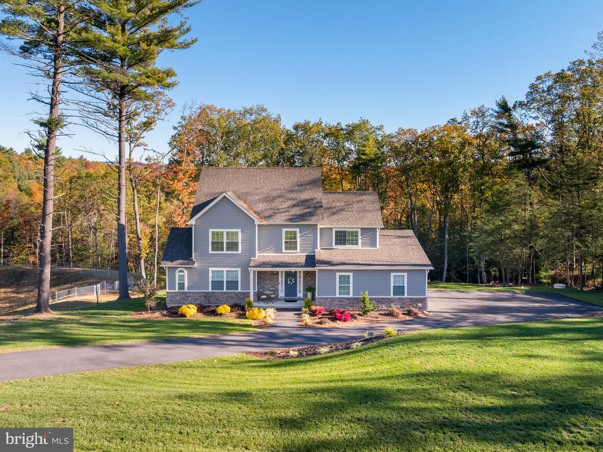 Completed in 2022, over 4,000sqft this modern Colonial offers luxury living. This home has been meticulously cared for. Set on 1.74 private acres, this 4-bedroom, 2.5-bath home features a bright, open-concept main floor with luxury vinyl flooring, granite countertops, a tile backsplash, farmhouse sink, gas cooktop with stainless hood vent, wall oven, and a walk-in pantry. The living room impresses with cathedral ceilings, a gas fireplace, and expansive windows that fill the space with an abundance of natural light — so much that you could spend the entire day inside without ever needing to turn the lights on. The sunlight streaming through creates a warm, inviting atmosphere and highlights views of the peaceful backyard. A versatile room on the main level offers the perfect spot for a home office, playroom, or additional living space. Upstairs, the primary suite is a true retreat with a walk-in closet and a spa-inspired ensuite featuring dual sinks and a tiled walk-in shower. The finished third floor provides an ideal fourth bedroom or bonus room, while the walk-out lower level offers endless potential for future expansion. Step outside to a private deck — the seller's favorite place to relax and enjoy the quiet surroundings. This is not your typical HOA: you can ride golf carts and scooters, kids can easily walk to friends' homes, and the bus stop is conveniently located at the cluster mailboxes. The neighborhood is known for its friendly community vibe — even handing out full-size candy bars on Halloween — and is just minutes from ShopRite, local restaurants, schools, and everyday conveniences. Don't be intimidated by the size of this home — it's impressively energy-efficient. Despite its spacious layout, you'll be pleasantly surprised by how low the monthly utility costs are, making luxury living both comfortable and affordable. Families will love the location — Intermediate and Elementary Schools are just 4 minutes away (yes, we timed it!),

while the Middle School and High School are only 9 minutes away. Come take a look to see this in person.