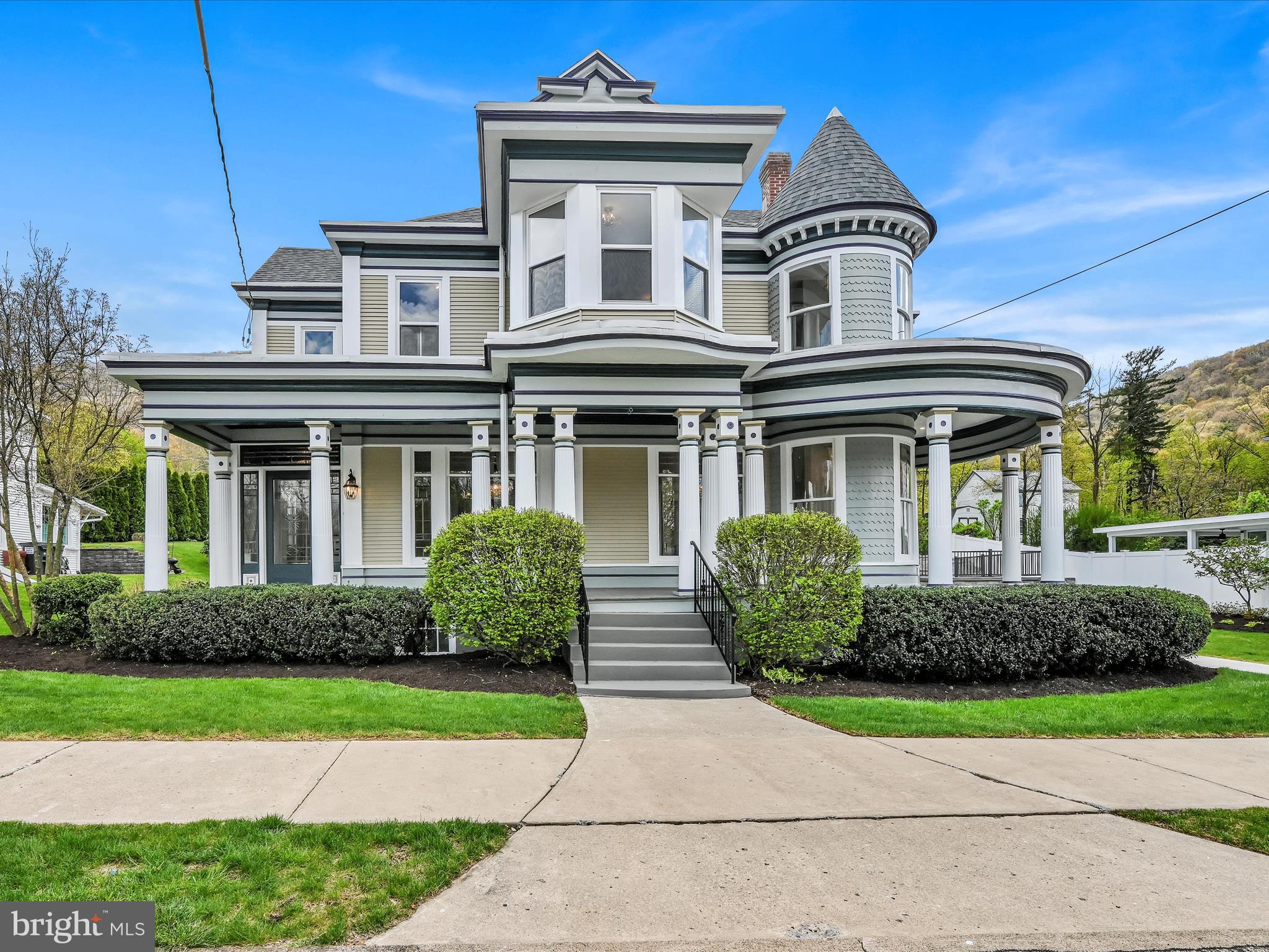 This exquisite Victorian residence, dating back to 1903, seamlessly blends historic charm with modern amenities.  Nothing was missed in this professional renovation with forward thinking updates to go along with encapsulating the charm of yesteryear. Meticulously renovated over the past two years, the home boasts over 5000 sq. ft. of living space, exuding timeless elegance at every turn.  As you approach, the attention to detail is evident, from the freshly painted period-specific exterior to the inviting wrap-around porch, perfect for enjoying leisurely moments outdoors. Stepping inside, a leaded glass front door with a transom welcomes you into the tiled foyer, where an ornate open staircase and refinished hardwood floors set the stage for the grandeur within. The living room, adorned with curved glass windows and decorative leaded glass, offers a cozy retreat, while the adjacent dining room features exquisite walnut inlays on the floors. Flowing seamlessly into the family room, this space is ideal for gatherings and leads to the most amazing and stunningly newly renovated kitchen. A chef's dream, the kitchen boasts quartz countertops, a 10 ft. black walnut island with ample seating, top-of-the-line appliances including a 5-burner gas stove and double smart ovens, and a separate serving area. French doors lead from the breakfast area to a expansive hardscape patio with a built in gas firepit, perfect for outdoor entertaining. Upstairs, four bedrooms exude old-world charm with operable transoms, hardwood floors, and unique light fixtures. The primary bedroom impresses with a sitting area, built-in closet features, and a luxurious ensuite bathroom with a glass surround tile shower and double vanity. Two additional full baths and a laundry room complete the second floor, while the finished third floor offers versatile space for an additional bedroom or flex room. Numerous updates including HVAC units, roofs, exterior paint, windows, and gutter/downspout system ensure both comfort and peace of mind. Conveniently located just minutes from I-81, this home offers easy access to both work and leisure. Schedule your personal tour today and experience the epitome of refined living!