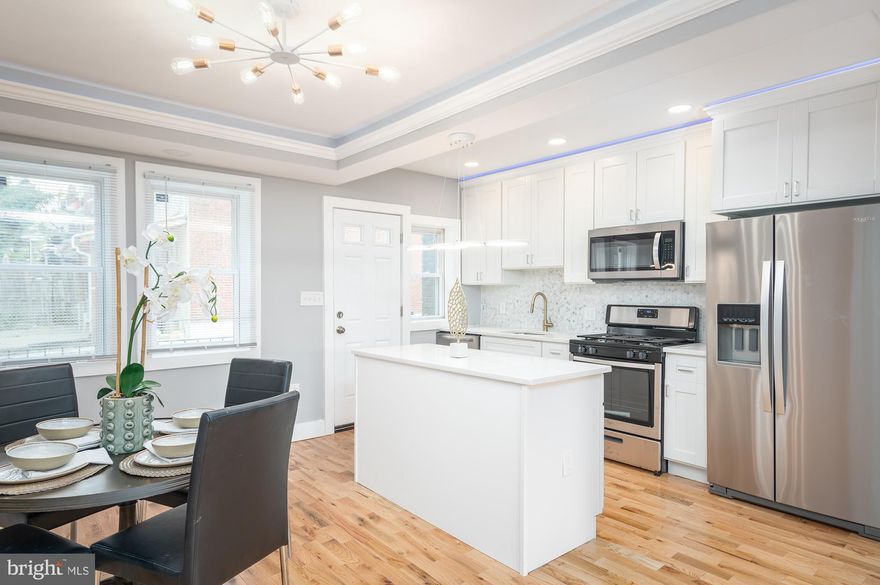 REMARKABLE RENOVATION WITH 3 FINISHED LEVELS AND DESIGNER FINISHES!  Gleaming hardwood floors throughout the main level, spacious living room with a tray ceiling and rope lighting, separate dining area, designer island kitchen with granite counters, ss appliances & tile backsplash, upper level with 3 bedrooms and 1 full bath, fully finished basement with a family room, 4th bedroom, and 2nd full bath.  Pack your bags and move right in!