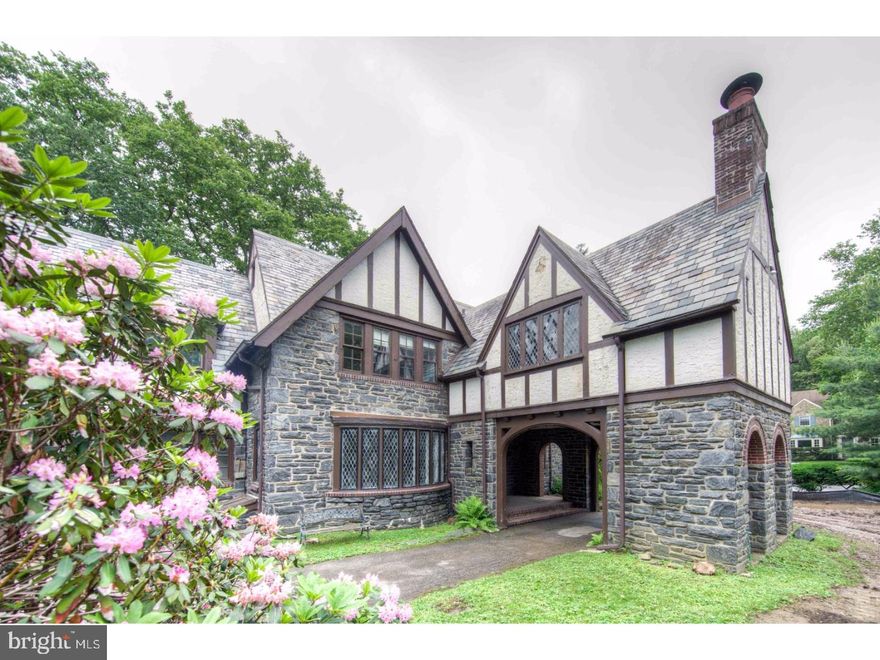 Amazing architectural features abound in this unique Tudor house built in 1925. In the highly sought-after Merion Park Neighborhood and formerly owned by the DePasquale Family (those music buffs know Joseph DePasquale reigned for five decades as one of the great violists in the 20th Century), this home is rich with history and charm.  The exterior boasts a gorgeous portico and entrance. High ceilings, stone walls, stained glass windows, gleaming woodwork and private yard are a few other noteworthy features. Entering the home you will find yourself in a large entry hall which opens into the Dining and Living Rooms. The wood paneled Living Room has a large fireplace, built-in cabinets and French doors which open onto an octagon shaped screened in Porch. The Dining Room, with an over-sized bay window, provides a gracious space for entertaining and living. Continue to the Kitchen and Breakfast Room which are intimate and conveniently open to a pantry/mudroom with easy access to the back patio. Climb the curving staircase and you will find yourself in a large hallway opening to an amazing "Harry Potter" style Family Room, complete with cathedral, beamed ceilings, built-in shelving, stained glass leaded windows and original copper fireplace hood!  4 bedrooms, 3 baths, a laundry room, and a large walk-in linen closet with original built-in cabinetry complete the 2nd floor. The unfinished Basement provides an abundance of storage space.  A rare opportunity - this special home is ready for you to bring your personal touch and restore it to its former glory! Showings begin Monday, 6/12.