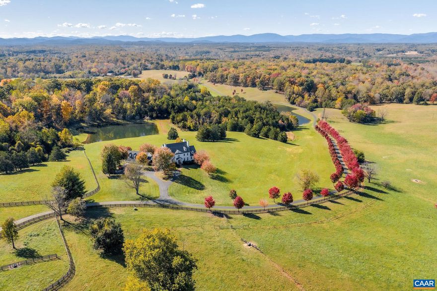This extraordinary Georgian estate is set on 179 acres with two ponds, seven natural springs, and two barns, offering timeless elegance in a truly remarkable setting with additional subdivision and vineyard potential. Designed for both entertaining and everyday living, the home blends historic charm with modern comfort, all while capturing breathtaking mountain views from nearly every room. The main level offers a graceful mix of formal and casual spaces, including a first-floor primary suite, antique heart pine floors, and a handsome study. Upstairs, a second primary suite with a renovated bath enjoys panoramic vistas, complemented by three additional bedrooms with en-suite baths. The lower level is designed for recreation with a large screen viewing area, wet bar, billiards room and provides a welcoming guest bedroom, full bath and office. Seven fireplaces add warmth and character. Outdoor living boasts a free-form pool, wide porches, and sweeping vistas. A four-car garage with portico has a second floor roughed-in. Every detail reflects quality and sophistication, making this estate a rare opportunity where land, luxury, and lifestyle come together, and every feature is designed to elevate gracious country living.,Granite Counter,Wood Cabinets,Fireplace in Basement,Fireplace in Dining Room,Fireplace in Family Room,Fireplace in Kitchen,Fireplace in Living Room,Fireplace in Master Bedroom,Fireplace in Study/Library