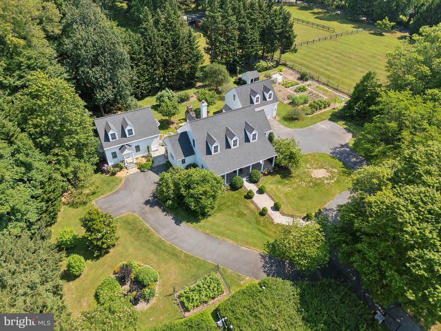 Welcome home to this idyllic, gated oasis comprised of a one-of-a-kind, custom-built compound nestled in the heart of Great Falls. Set well off the road on 2.5+ acre for privacy, this stunning property includes the main house, separate in-law cottage, detached two-car garage with living space above, impressive organic vegetable and flower gardens, and expansive lawns. The upper acre is surrounded by a 10-foot deer fence to allow for gardening. Read on for more information and request document for a comprehensive list of details, too many to list here! Total of 6 BR 4.5 baths among the 3 structures. 

Main House -4BR 3.5 BA  (4016 SF ) custom built by Kohler homes. The deep front porch invites you into the 2-story foyer that is flanked by an office with custom built-ins to the left and the spacious formal dining room to the right. Columns in the dining room match the columns on the front porch. As you walk forward from the foyer to the family room, your eyes will be drawn to the view of the beautiful back yard through French doors that lead out to the flagstone patio with custom masonry fireplace with a lovely iron detail from Cape May. The generous family room with custom built in cabinets, wood burning fireplace with granite surround and hearth, and detailed crown molding is just off the chef’s kitchen. Preparing meals for friends and family will be a delight in this beautiful space with custom Tedd Wood cabinets, large island with seating, Subzero refrigerator, GE Monogram under-counter refrigerator, Thermador glass cooktop, Bosch dishwasher, two sinks, granite counters, reverse osmosis water system, walk-in pantry, and remote-controlled honeycomb blinds. Also off of the kitchen is a convenient laundry/mudroom and side entrance. 
Rounding out the main level is the primary suite with two walk-in closets, elegant bathroom with his and her sinks, heated floors and shower walls, walk-in shower with glass surround and door, separate tub, separate water closet, custom cabinets, and remote-controlled honeycomb blinds over the tub. French doors leading Upstairs you will find two large bedrooms with large closets, and a shared Jack and Jill bath along with a linen closet. 
The finished basement includes a large gym, media room with surround sound, bedroom with large closets (currently being used as an office), full bathroom, and other finished and unfinished storage areas. The heating system in the utility room is a work of art!
Throughout this incredibly well-built custom home you will find hardwood floors, 6” exterior walls for extra insulation, radiant gas heat, tall base boards, deep crown molding, Lutron Maestro switches, and recessed lights galore. Sliding covers on outlets for safety and insulation. 
The In-law cottage 1 BR 1 BA  (1586 SF ) was designed to complement the main house and greets with a delightful portico. Inside you will find a full kitchen with custom cabinets, granite counters, reverse osmosis water system, laundry closet & breakfast nook. The cottage is complete with a luxurious bath with spacious shower, main level bedroom, upstairs office/living room, and finished basement. Beautiful hardwood floors throughout living areas and tile in the bathroom and basement. Custom built in 2015 by local Foley Homes. 
The studio apartment  1 BR 1 BA (434 SF) above  the two-car garage is perfect for guests or an au pair. The kitchenette has a granite counter, custom Tedd Wood cabinets, GE under counter refrigerator/freezer, microwave and sink. The bath has granite counters, shower w/ glass door, and a Whirlpool Heavy Duty Twin-Thin stacked washer/dryer. New 3-Day Blind honeycomb shades on the windows and door. Your guests are sure to enjoy the beautiful view of the garden from the east window!
This serene setting is worlds away from traffic and noise yet close to shopping in Great Falls, Reston, Sterling and easy access to commuter routes; FFX County Pkwy, 267 and Reston Wiehle Metro. Langley High School pyramid