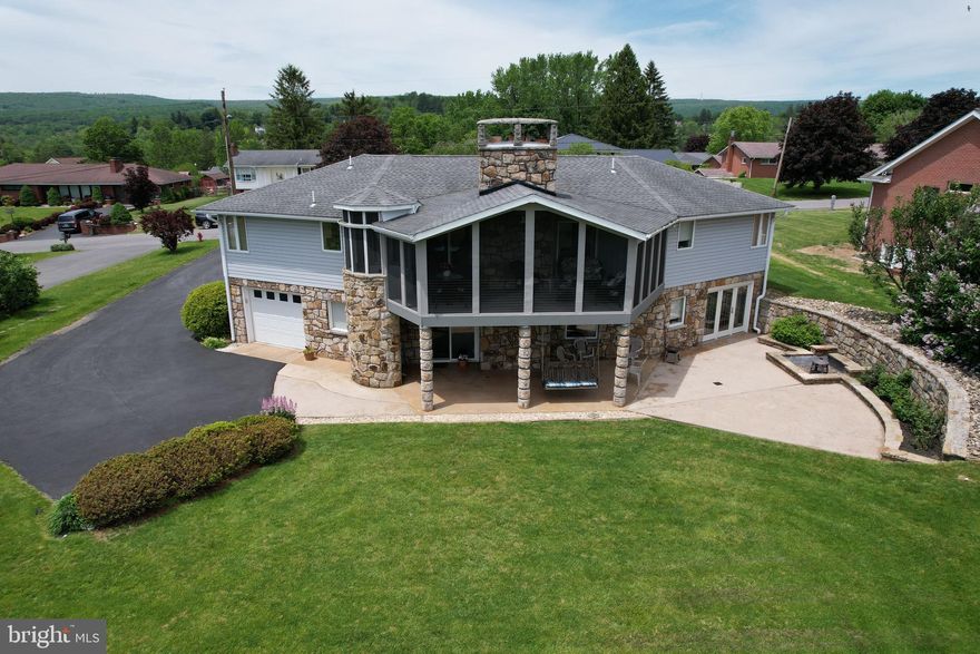 Welcome to this beautifully designed, modern home featuring three bedrooms and three bathrooms. The journey begins along a charming stone sidewalk leading to a spacious concrete patio and then the inviting front door. Inside, you'll enjoy one-floor living with an open-concept layout, highlighted by a barrel-vaulted ceiling, a cozy stone fireplace, and a convenient main-level laundry area.

Step outside onto the screened-in porch, where panoramic views of the mountains and pond create a serene backdrop for relaxation.  On either side of the main living area is the primary owner’s suite offering a double vanity and walk-in closet on one side, while a private secondary bedroom and bathroom are tucked away on the other, providing privacy and comfort.

Ascend the elegant circular staircase to the finished basement, which features a versatile family room, an office, a third bathroom, and a third bedroom—including a sauna and an expansive walk-in closet. The third bedroom, with a wall of glass, opens onto a concrete patio, edged with a stunning stone retaining wall, perfect for enjoying outdoor gatherings.

The lower level offers additional outdoor living spaces, including adjoining patios ideal for relaxing in the evening on the porch swing while observing wildlife at the pond. The home also boasts ample storage, including two separate basement garages.

Meticulously maintained and full of charm, this gorgeous home is a rare find. Don’t miss your opportunity— Call today to schedule a tour!