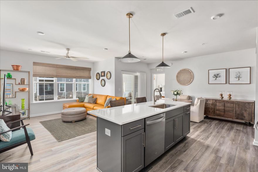 Welcome to this stunning new one-level active adult condo in the premier Cascades at Embrey Mill community where comfort meets style. Step into a spacious foyer with an elegant tray ceiling and an open floor plan featuring luxury vinyl plank floors and designer finishes. Welcome to this stunning, one-level active adult condo in the premier Cascades at Embrey Mill community where comfort meets style and low-maintenance living. Step into a spacious foyer featuring an elegant tray ceiling and an open-concept floor plan enhanced by luxury vinyl plank flooring and designer finishes throughout. The chef-inspired kitchen is the heart of the home, showcasing a large island with bar seating, quartz countertops, custom backsplash, stainless steel appliances, modern gray cabinetry with pull-out shelves, and a generous walk-in pantry. The kitchen flows seamlessly into the dining area and bright, inviting living room which is perfect for entertaining or relaxing at home. A versatile built-in office with custom cabinetry creates the ideal work-from-home space. The laundry room offers added convenience with a GE Profile washer and dryer. Retreat to the luxurious owner’s suite featuring a spacious walk-in closet and a beautifully appointed bath with dual quartz vanities, a frameless glass shower, private water closet, and upgraded tile package. Your guests can relax in one of the two additional bedrooms that share a spacious full bath. Enjoy beautiful sunset views from your private balcony. Additional highlights include: Samsung Bespoke French Door refrigerator, pendant lighting in the kitchen, ceiling fans in bedrooms and living room, custom blinds and shades including motorized blinds in the living room, custom accent wall in the guest room, professionally painted one-car garage (5ft larger than most models), separate storage closet and a shared elevator. This home is equipped with smart-home technology, including a programmable thermostat, keypad entry, CAT6 wiring, and energy-efficient construction for modern living. Residents of Cascades at Embrey Mill enjoy resort-style amenities, including a clubhouse, pool, fitness and yoga studio, patio with fire pit and grills, pickleball and bocce courts, and more. Do not miss your opportunity to own this exceptional home. Schedule your private showing today!