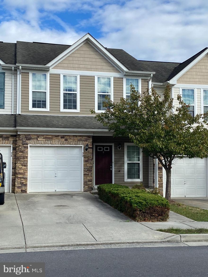 Beautiful townhome in Martinsburg features 2 bedrooms, 2 bathrooms, kitchen, dining area, living room, laundry area, 1 car garage, and small yard.