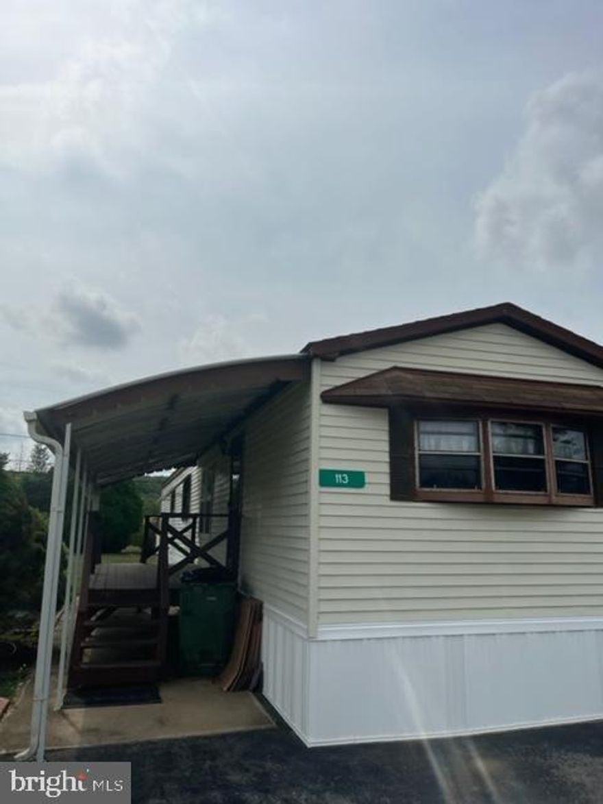 Adorable & Affordable mobile home in Windy Brae Mobile Home Park. This 2 bedroom 1 bath home has a large open kitchen w/breakfast bar. Luxury vinyl plank flooring throughout.  Full bath has vanity area and soaking tub/shower combo. The covered front porch is a great space for relaxing and bird watching. Park rent is $440 per month which includes trash pickup. Contingent on Buyers being park approved.