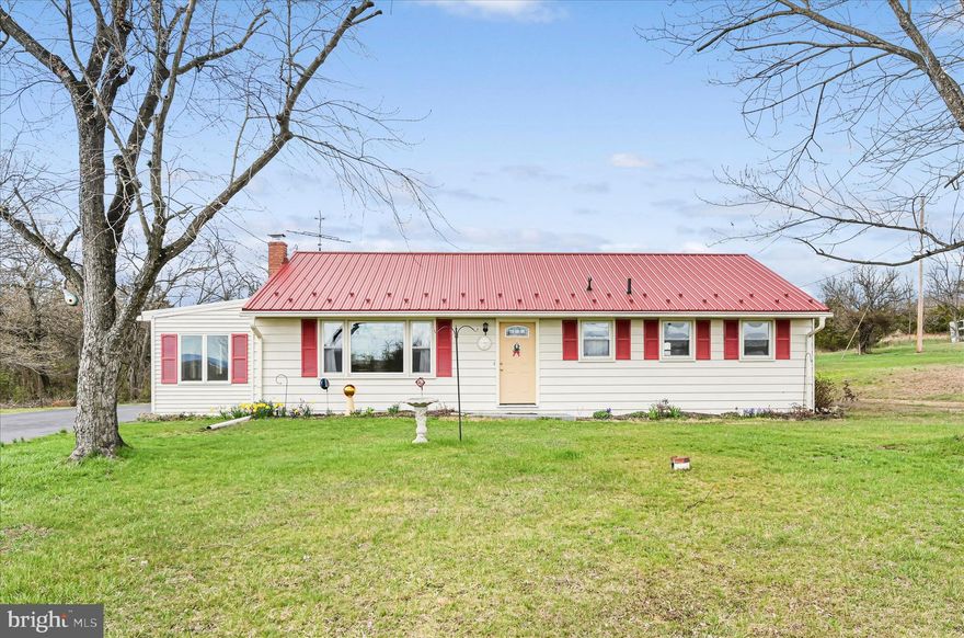 This solid ranch home in a peaceful country setting is ready for your vision. On just over an acre, it features a large living room with replacement windows, hardwood floors under the carpet, & accessible bathroom. Enjoy the bright 3-seasons room & expanded driveway with ample parking. The metal roof is newer. Storage is abundant with a waterproofed basement & pull-down attic. The move is on!