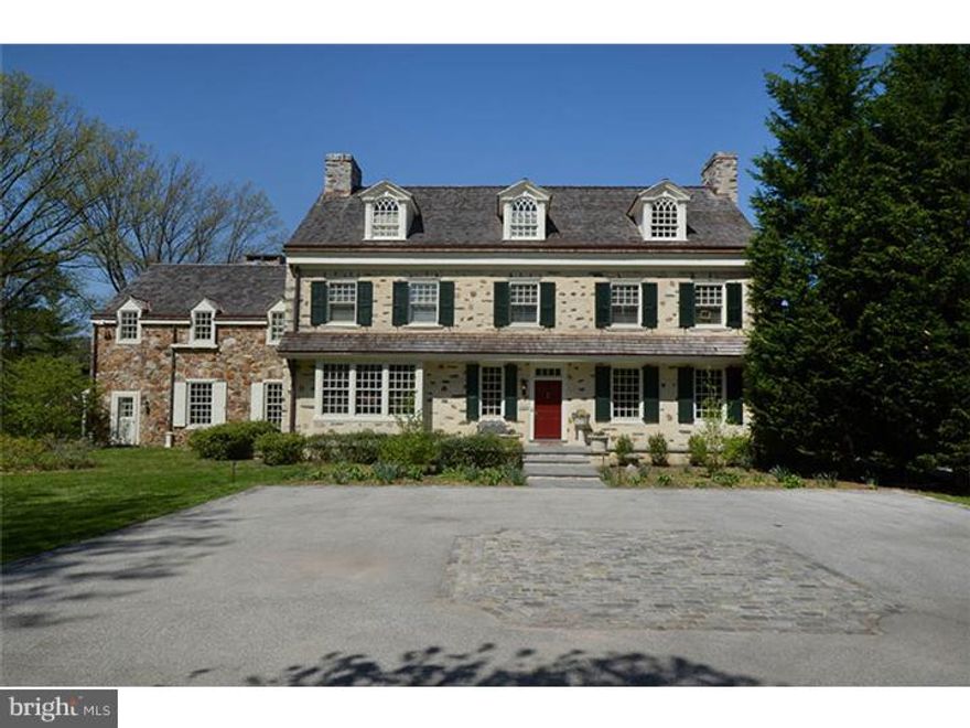 Magnificent Colonial Revival Farmhouse designed by Brognard Oakie, set on 2.02 pastoral acres has been comprehensively renovated by the current owners under the superior direction of Orion construction. Originally built in 1930, this extraordinary home offers five bedrooms, five full baths in the main house and expanded, independent guest quarters with kitchen above a striking shingle styled four car garage with lit cupola.  Hallmarks of the Oakie design including heavily mortared stone work adjacent to "undressed stone" additions, pair seamlessly with interior appointments such as ornamental forged iron hinges, deep window sills and wide planked blonde wood flooring. Mature plantings, wide stone terraces, covered side porches and two gated points of entry create a bucolic, sylvan setting belying the homes location, just minutes to Philadelphia's center.