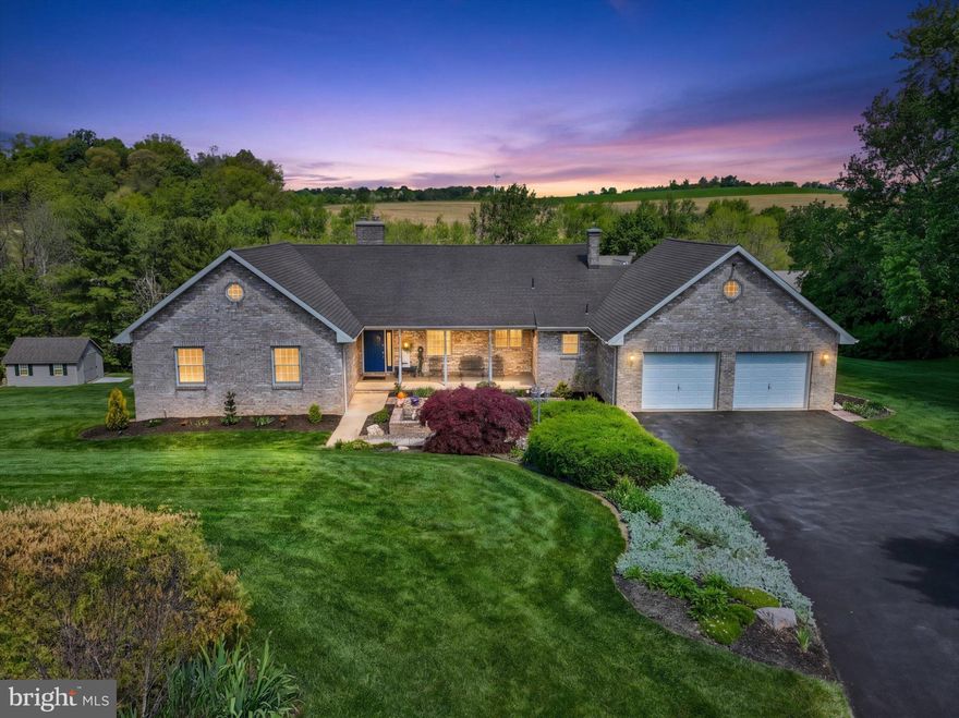 Nestled in nature just moments from Wyndridge Farm, this sprawling over 4000 SF of living space brick rancher with walk-out lower level offers the perfect blend of privacy, flexibility, and scenic countryside living. Set on nearly an acre with sweeping “sea of green” views, this 4-bedroom, 3.5-bath home was designed for both comfortable everyday living and effortless entertaining. Well-built home in which owners have taken great pride and meticulously maintained.

Step inside to discover soaring vaulted ceilings in the great room including an arch top brick fireplace with mantel and a sliding French door opening to an expansive deck overlooking a pond and tranquil landscape. The beautifully updated eat-in kitchen featuring granite counters serves as the heart of the home, while the spacious primary suite features its own private deck retreat and en-suite bath with peaceful views in every direction.
The finished walk-out lower level dramatically expands the living space with a kitchen/dining area combo equipped with electric cooktop and microwave. Sliding glass door allows direct access to a covered patio - creating the ideal setup for gatherings, hobbies, or multi-generational living. A private lower-level wing featuring two additional rooms, a full bath,  closet, and window offers excellent potential for an in-law suite or guest quarters. The lower level does not feel like you are in a basement. The ceilings are high and there are lots of windows and a sliding door to a covered porch and hot tub. French doors lead you into a private office space.

Now for the additional highlights, Newer windows, furnace, water heater, water softener and brand new AC unit adds to the peace of mind! 3 zoned heating for personalize comfort, excellent storage and even additional walk-up attic space with ceiling height suitable for future finishing. Oversized 2 car garage and storage shed. This is a rare opportunity in Dallastown Schools to enjoy spacious country-style living with versatile spaces and exceptional views in a highly desirable location.