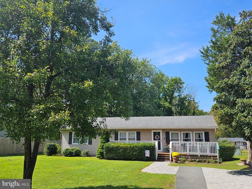 Welcome to 220 Pennick Drive, a charming 3-bedroom ranch-style home nestled in one of Kent Island's most desirable waterfront communities, Romancoke on the Bay. Conveniently located between the Chesapeake Bay and Eastern Bay, this low-maintenance lot allows you to fully enjoy a variety of outdoor pursuits.
Just a short walk or bike ride away, you’ll find the Romancoke fishing pier, along with a boat ramp, beach access, picnic areas, and a community clubhouse. The Kent Island South trail culminates at Romancoke, offering countless scenic pathways for walking and biking. Golf lovers will be thrilled with the proximity to Blue Heron Golf Course. With three public beaches, parks, marinas and a sports complex all nearby there are endless possibilities to pursue a  variety of different activities. There is a diverse selection of local shops and restaurants, many of the restaurants with waterfront views just a short drive away on Kent Island.
Step inside this inviting 1,500 sq ft home from the welcoming front porch into a bright and airy living room that transitions effortlessly into an open-concept kitchen and dining area. The heart of the home is the all-season sunroom, showcasing a vaulted ceiling, recessed lighting, and a newly installed wood-burning stove—ideal for year-round relaxation while enjoying views of the serene backyard and mature woodlands.
The main bathroom has been thoughtfully updated with an ADA-compliant walk-in shower. Additional updates include newly installed interior doors, a crawl space with a new sump pump and encapsulation, a new front storm door, and a french drainage system. This home beautifully merges original charm, including hardwood floors, with modern enhancements, making it ready for you to move in and enjoy immediately!