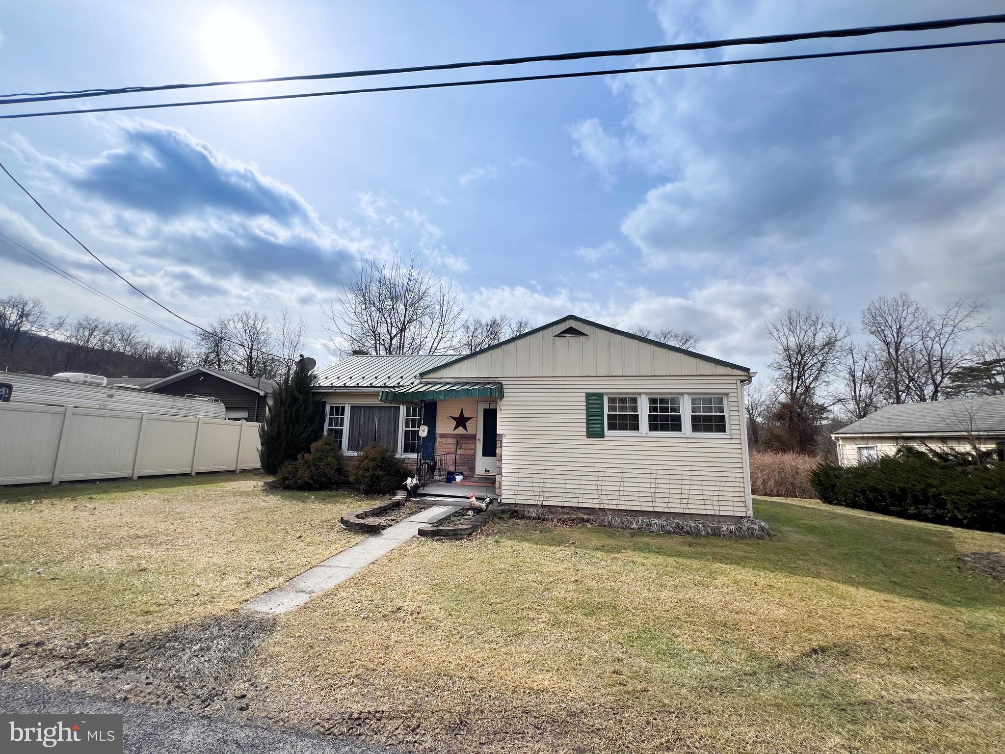 Country Ranch. Enjoy this three bedroom ranch in rural setting. Some hardwood floors and spacious eat in kitchen. Newer metal roof in 2018. Enclosed back porch walks out to pool and deck. Firepit in rear yard as well. One car detached garage.