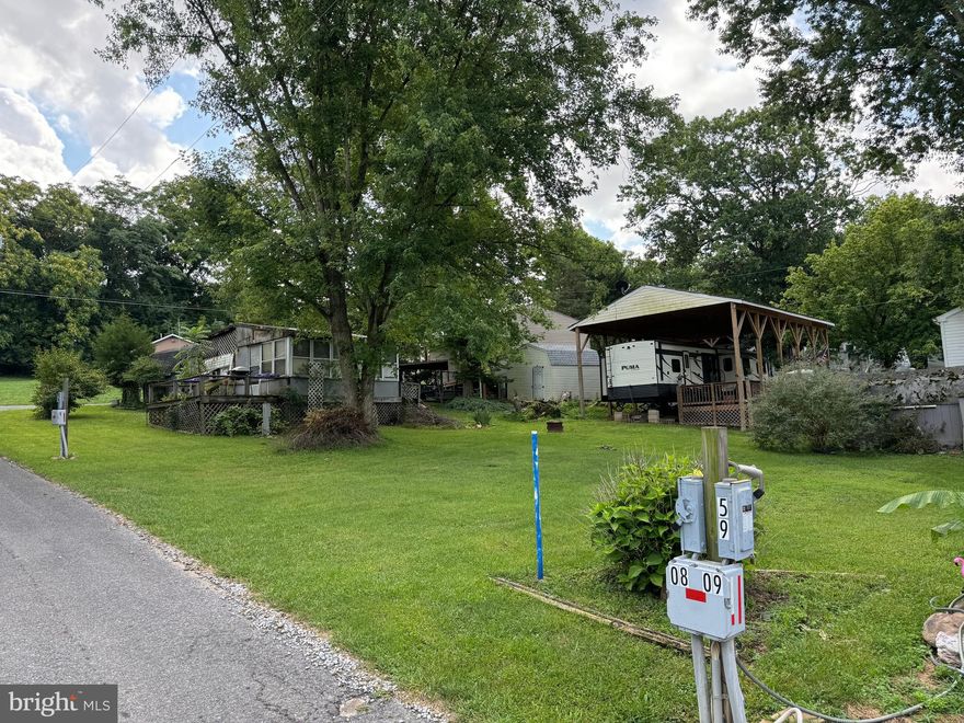 Double lot! 0.14 total acres in an amazing location only 1 block from the river. Small camper with two beds, kitchenette, and half bath. Large porch attached for extra living space and shed for storage. Separate water and electric hookups for each lot. Use the second lot for an additional camper and still have plenty of room for parking vehicles and boats. Seasonal campground, gated community, open from April 1 to November 1 with river access and amenities, 3 amazing swimming pools, restaurant, chapel, horseshoe pits, mini golf, playgrounds, basketball and tennis courts. Very active community with many events including bingo, flea markets, car shows, festivals, and so much more. Come enjoy your summer at this relaxing gem. (HOA fee is per lot -$3,450 total, yearly)