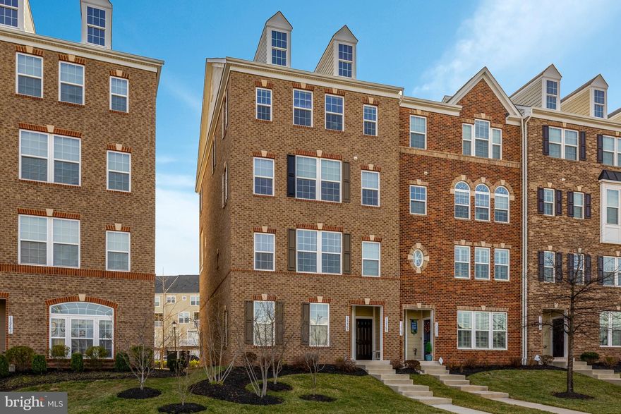 Own this exceptional upper end-unit condo featuring 3 bedrooms and 2.5 baths, with a builder's estimate of 2,611 total square feet—2,516 of which are on the upper two levels. This home includes a one-car garage and driveway parking for an additional vehicle.

The condo showcases stylish designer upgrades, such as high-end hardwood flooring, cabinetry, granite countertops, and upgraded bathroom tile and fixtures. As a corner unit, it is filled with natural light from additional windows, creating a bright and airy atmosphere throughout. Enjoy stunning sunsets from the comfort of your home.

The luxury condo features a spacious open floor plan with hardwood floors and an upgraded kitchen equipped with stainless steel GE appliances, granite countertops, and a stylish backsplash. Highlights include a primary suite with dual walk-in closets and a convenient laundry area with a washer and dryer located on the upper level.

Step outside to a private balcony off the family room, a spacious front yard, and additional storage space in the garage. The home also boasts modern finishes, including 9-foot ceilings, gas heat, and gas cooking. It is conveniently located within walking distance to parks and just minutes from the Air and Space Museum, Dulles Airport, major highways, and top-rated schools. Nearby shopping, restaurants, and entertainment options, as well as easy access to the Silver Line Metro, make this condo a prime choice for comfort and convenience.

The condo fee covers water, sewer, trash removal, snow removal, common area maintenance, lawn maintenance, road maintenance, playground access, jogging and walking paths, volleyball courts, common grounds, picnic areas, and a clubhouse. In today’s market, it is rare to find a condo fee this low with so many amenities included, even covering water bills. Additionally, there is plenty of guest parking available in the rear of the building.