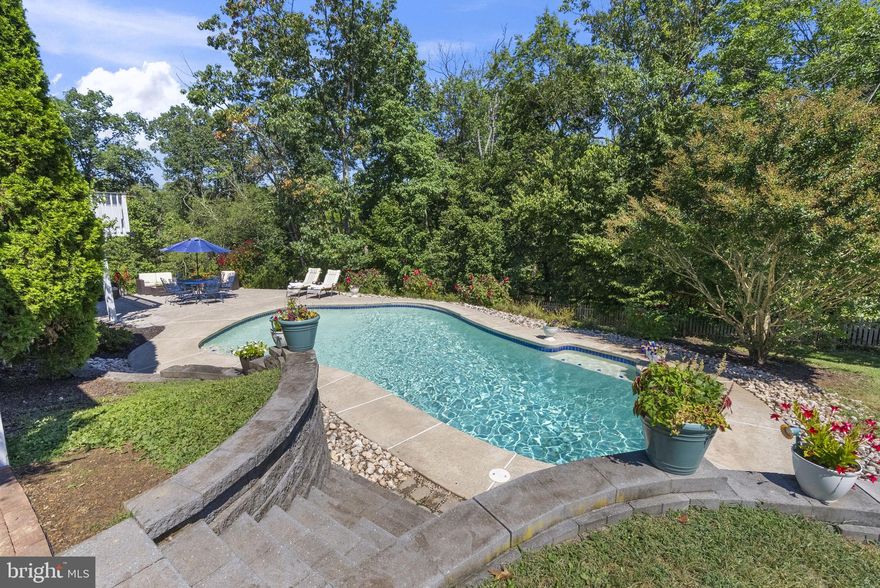 NO HOA, but with all the benefits of a maintained development. This beautiful 4-Bedroom Home for Sale in Collegeville, PA | Perkiomen Valley School District is located in Heather View.
A stunning 4-bedroom, 2.5-bath home for sale in Collegeville, PA offers almost 3,000 square feet of move-in-ready living space in a quiet, established Collegeville neighborhood. Surrounded by mature landscaping and wooded views, this property provides privacy, comfort, and exceptional indoor-outdoor living.
A bright two-story foyer welcomes you into an open floor plan featuring new luxury vinyl plank wood floors, fresh paint throughout, and abundant natural light. The updated kitchen includes granite countertops, island, custom cabinetry, and large pantry, opening seamlessly to a spacious family room with a wood burning fireplace—perfect for entertaining. Step outside to an upper deck overlooking a private wooded backdrop and in-ground swimming pool, plenty of yard for a garden and additional recreation ideal for relaxing or hosting guests. The laundry/mudroom offers direct access to the backyard and expansive hardscaped pool patio, enhancing everyday convenience. The home also features a dining room, a living room or flexible home office, a powder room, and an oversized 2-car garage with additional storage. Upstairs, you’ll find a hall bath, four generously sized bedrooms, including a luxurious primary suite with a sitting area/additional home office, a large walk-in closet, and an ensuite bathroom with soaking tub and New stall shower and toilet. 
The walkout basement adds valuable living space and opens directly to the pool and large backyard. It’s perfect for a recreation room with pool table, home gym, theater, or entertaining space.
Located in the award-winning Perkiomen Valley School District, this Collegeville PA home in Montgomery County has been extensively updated with a new furnace/AC, hot water heater, windows, flooring, throughout first floor, Front storm door, and bathroom upgrades, making it truly turn-key.
If you’re searching for a home with a pool, walkout basement, and space to grow in Collegeville Pennsylvania, this property checks every box. Schedule your private showing today and experience one of the most desirable homes for sale in Collegeville, PA.