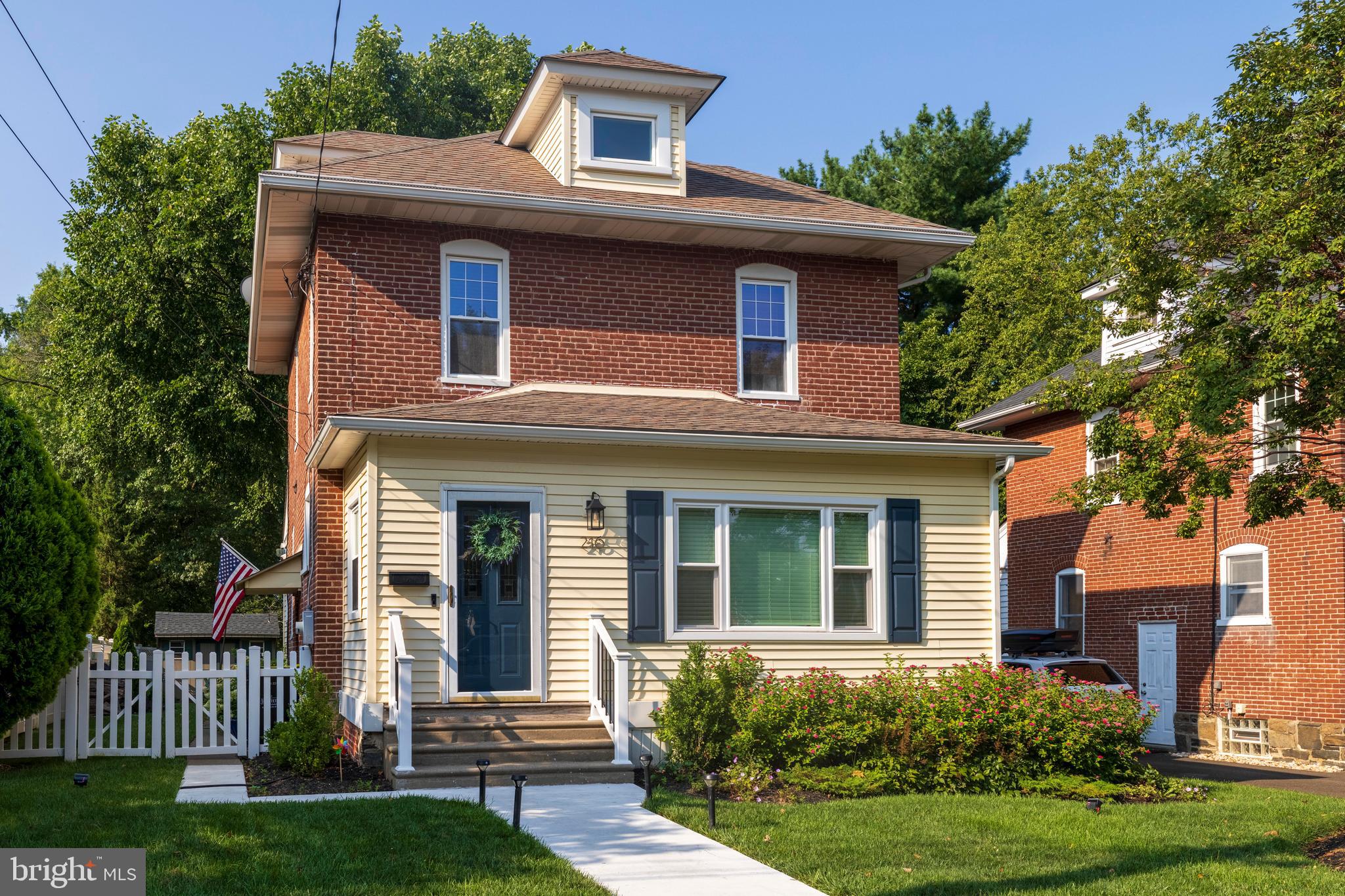 Welcome to 216 S. 4th Street, tucked away on a storybook block in North Wales Borough—just steps from award-winning North Wales Elementary and walkable to local shops, restaurants, the R5 train, parks and Green Ribbon Trail. From the moment you arrive, you’ll notice the thoughtful curb appeal: a newly refinished concrete walkway, updated front railings, and striking navy shutters and door—all completed in 2025. The fully fenced yard is enclosed by a crisp white vinyl fence (2021) and surrounded by extensive landscaping refreshed over the past three years—creating a private, picturesque setting for entertaining, gardening, or simply relaxing. The newly completed cedar walkout deck (2025) offers the perfect outdoor retreat. Inside, this home blends original character with well-planned upgrades. The living room and all second-floor bedrooms have just been painted (2025), and the home features solid hardwood interior doors (2024) and newly refinished trim throughout (2024)—enhancing the timeless warmth of the hardwood floors. Up front, a bright bonus space with newly replaced windows (2024) serves as the perfect home office, playroom, or reading nook. Continue into the sunlit living room and then to the heart of the home: a custom eat-in kitchen with shaker-style cabinetry, granite countertops, tile backsplash, farmhouse sink, 5-burner gas range with double ovens (one convection), wine fridge, built-in microwave, and smart storage touches like pullouts, a hinged spice rack, and hidden trash compartment. Beyond the kitchen, a heated mudroom with built-in cubbies connects to a private powder room and first-floor laundry. A new sump pump (2024) ensures peace of mind, and a high-efficiency ductless A/C system (2021) keeps the home cool and comfortable throughout the summer. The sewer line was also updated in 2021, adding long-term value and reliability. Upstairs, you’ll find a full bath with radiant towel-warming heat and three cozy bedrooms with hardwood flooring and ceiling fans. And here’s the bonus: the walk-up attic was just finished in 2024, adding an additional 220 square feet of flexible living space—ideal for a 4th bedroom, home office, or creative retreat. The sellers have thoughtfully invested over $125,000 in upgrades and improvements, with every decision made to enhance comfort, functionality, and style. From mechanicals and major systems to cosmetic updates and expanded living space, this home has been meticulously cared for and beautifully maintained. With a location that’s walkable to North Wales’ best amenities, minutes to the train, and a short drive to Wegmans, Whole Foods, and major routes (309, 63, and the PA Turnpike), this home is the perfect mix of charm, convenience, and move-in ready comfort. Don’t miss your chance to own a home that’s been lovingly updated and thoughtfully enhanced—schedule your tour today!