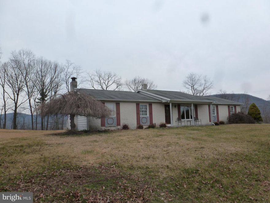 Terrific Location! Rural mountain views for miles. 2.4 open acres partially edged w/woods offers brick-faced home. Ambiance in lower level family room - white brick wall/wood fireplace. Additional option to hook up wood stove. Central air for summer comfort. Lovely Florida room w/ heated LP Gas. 2 car convenience attached garage. 40" x 37'.6 Detached 3 bay garage w/ 1 bay insulated/ another bay 12' width x 11' high. Hydrant water/200 amp electric offers all kinds of storage & hobby living options. Home needs some new flooring - so add your splash of color to make this house your home! You could even rent out garage space to help pay your taxes! 209' Rt 235 road frontage. Spacious lawn could be horse pasture. Qualified buyers welcome!