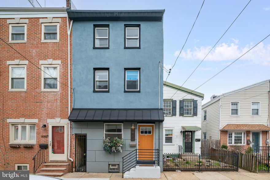 Welcome to 1443 E Oxford Street - spacious, stylish 16-foot-wide, custom-designed home perfectly situated in the heart of Fishtown - just steps from Frankford Avenue and within the Adaire Elementary catchment. Enter into a warm and inviting living room that flows seamlessly into a dedicated dining area, enhanced by an extra wall of windows that fills the space with natural light. The updated galley kitchen features stainless steel appliances, granite countertops, white cabinetry, fun and colorful floors, open shelving, and a pass-through window that keeps everything feeling bright and connected. The second floor offers a generously sized front bedroom with ample closet space, along with a smaller bedroom currently outfitted as a customized walk-in closet - easily converted back into a small bedroom, plant den, or home office depending on your needs! A full bathroom on this level features a one of a kind vanity made from reclaimed wood and custom tiles, includes a tub/shower combo and is large enough to house any additional bathroom storage. Another set of stairs lead up to a private primary bedroom that can be closed off to the floors below for complete peace and quiet. The primary also has a ton of closet space and natural light - plant-lovers will thrive in this house! Out back, you'll find a Fishtown unicorn - a huge backyard, truly your own private oasis complete with a mural by Glossblack, and plenty of space to relax, unwind or entertain. Additional highlights include hardwood floors throughout, custom brick accent walls along the first and second floors, a custom sliding barn door, basement for additional storage and laundry, and brand new 100-amp electrical service for added peace of mind. All of this just literal moments away from neighborhood favorites like Fishtown Social, Van Leeuwen Ice Cream, Suraya, Philly Style Bagels, Kalaya, LMNO, Palmer Park, Berks Street Station, and everything else Fishtown has to offer!