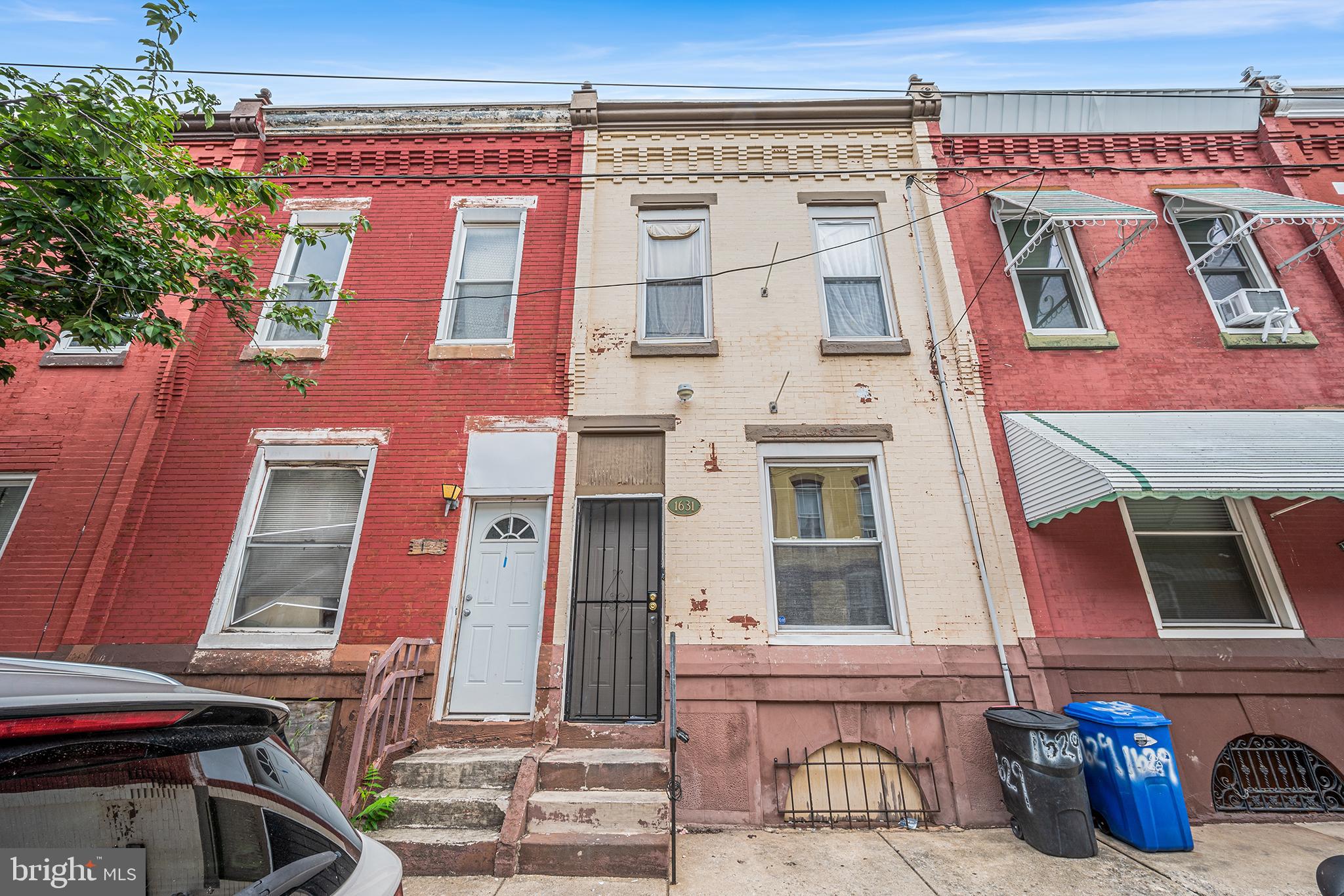 Welcome to this beautifully updated rowhome located on a quiet, tree-lined street in Northwest Philadelphia, just two blocks from Temple University and close to public transportation. Enter inside to a spacious open-concept layout where the living and dining areas flow seamlessly into the kitchen. The kitchen features ample cabinet and counter space, a brand-new tile backsplash, and a door that leads out to a private rear patio surrounded by greenery—creating a true outdoor oasis ideal for relaxing or entertaining. Just off the kitchen, a first-floor bedroom offers flexible space for a dedicated home office, playroom, or guest room. A convenient half bath completes the main level. Upstairs, you’ll find three comfortable bedrooms, including a spacious rear primary bedroom. One of the secondary bedrooms includes a built-in lofted bed, perfect for maximizing space. All three bedrooms share a large, updated hall bathroom. The full unfinished basement provides plenty of room for storage and includes the laundry area, with potential to be finished for additional living space. Recent updates include a new roof installed in 2023 with a 12-year transferable warranty, a new Kenmore A/C unit installed in 2022, and fresh paint throughout the entire home—including walls, ceilings, and doors. This move-in ready home is a wonderful opportunity to own a stylish and comfortable property in a vibrant neighborhood near all that Temple University and the city have to offer.