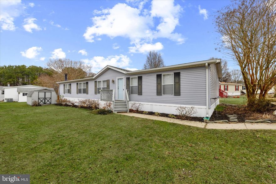 Bright, spacious, and Mostly Furnished! This thoughtfully updated home in Angola Estates is being sold mostly furnished, and offers an expansive yet comfortable layout that works just as well for everyday living as it does for gathering with friends and family.  TWO dining areas (three if you include the massive island), TWO living areas! The open-concept kitchen, family room, and casual dining area create an easygoing space where everyone can be together. The kitchen has been refreshed with refinished cabinetry, granite countertops added in recent years, updated appliances (approximately 2021–2022), an oversized center island with an overhang for seating, and generous pantry storage. The large table space features a patio door  leading to the deck, while the nearby laundry room includes a convenient half bath with an updated vanity.  The adjoining family room is filled with natural light and a corner fireplace adds a cozy touch. 

Toward the center of the home, a separate living room and dining room, both with refreshed carpeting, offer additional space for hosting holidays, movie nights, or simply enjoying a quieter section of the house.

Down the hall, the bedroom wing includes two comfortable guest rooms and a full bathroom with an updated vanity. The primary suite offers a relaxing retreat, with French doors leading to a private bathroom featuring two distinct areas: the first with a soaking tub and spacious vanity, and the other with a stall shower and commode.

Sliding doors open to a large wraparound deck overlooking the backyard, creating a natural extension of the living space and an inviting place to enjoy morning coffee, casual dinners, or warm summer evenings outside.

Many improvements were completed around 2021, including the heating and cooling systems, lighting updates, flooring, doors, fixtures, ceiling fans, and interior paint in most rooms, contributing to the home’s well-maintained feel. The seller is even offering a 1 year HOME WARRANTY for your peace of mind.

Residents of Angola Estates enjoy a variety of community amenities designed for relaxed coastal living, including two swimming pools, playgrounds, tennis and basketball courts, pet relief stations, and a community center that hosts resident-planned activities and gatherings. A fishing pier, floating dock marina with boat ramp, and storage yard for boats and RVs add to the convenience. Sewer and trash/recycling are included in the monthly lot rent, and fencing is permitted.

Residency application required, including credit and background checks and verification of income and/or assets.