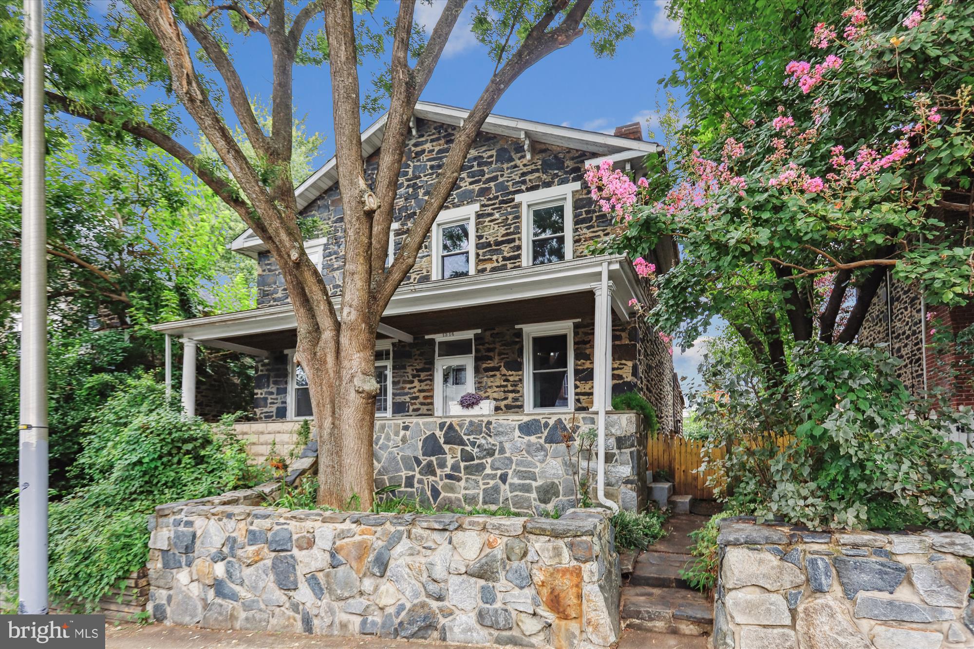 Step back in time with this charming 1850s stone mill house, nestled in the heart of Hampden. Lovingly maintained, it radiates warmth and peaceful cottage charm the moment you arrive. A spacious, inviting front porch sets the tone—perfect for lazy afternoons with a book or welcoming friends and neighbors. Inside, the home surprises with large, airy rooms and an abundance of kitchen cabinet and counter space, making it both practical and comfortable. Original wide-plank wood floors add character and history underfoot, while the convenient main-level laundry and bathroom make everyday living a breeze. Upstairs, two generously sized bedrooms provide cozy retreats, and pulldown stairs lead to a fully floored attic—ideal for storage, or future possibilities. The unfinished basement is clean and spacious, ready for hobbies or extra storage. Recent updates include a newer asphalt shingle roof (2023.) Out back you’ll enjoy parking for up to two cars, along with a private rear deck that feels like a hidden oasis! The fenced side and rear yards are ideal for gardening, pets, or simply relaxing outdoors. So peaceful yet conveniently situated close to Artifact Coffee, Blue Pit BBQ, La Cuchara, The Avenue, Woodberry Light rail, and so much more! This Hampden gem offers the best of historic charm and modern comfort at an affordable price! (As-Is)