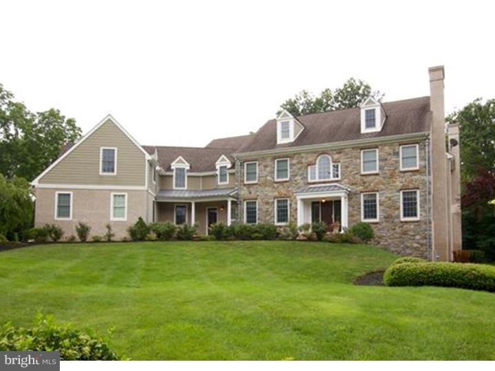 Classic 6-year-old custom Colonial home situated on 1.18 acre lot in desirable Northside Villanova featuring over 8000 sq. ft. of living space. Quality and attention to detail are evident throughout. Enter into 2 story Foyer with richly stained hardwood floors, wainscoting, and detailed millwork. To the right, enter into elegant formal Living Room with gas fireplace, two exposures, wainscoting and deep crown molding. This leads into hallway with formal Powder Room and into a den/office with gas fireplace and access to deck. To the left of foyer is a formal Dining Room adjacent to Butler's Pantry with Subzero beverage/wine refrigeration, custom cabinetry with seeded glass and granite countertops. Enter into Kitchen with seemless hardwood floors, professional Wolf range, 48" side-by-side Subzero refrigerator, built-in microwave, oversized island with sink and seating, granite countertops and tumbled marble backsplash. Kitchen opens into Family Room with coffered ceiling, Stark carpet, wood burning fireplace and grass cloth wallpaper. Kitchen also opens into sunny breakfast room with cathedral ceilings, 3 exposures and access to deck. A large Pantry, Laundry Room, Mudroom and family Powder Room complete the first floor. Ascend the traditional turned staircase and enter through double doors to the luxurious Master Suite with crown molding, separate seating area with architectural window and walk-in closet. Master Bath includes double sinks, vanity, jacuzzi tub with marble surround and tumbled marble floors. Second floor also features second bedroom with ensuite bath, Jack and Jill bedrooms with large bath with double sinks, and a fifth bedroom with large sitting room and bathroom, which could function as a guest suite, home office, or in-law suite. Third floor offers large, finished bonus space. Open stairs to walkout lower level with 3 full windows and two exposures around sitting area. Separate room with brick floors functions as a gym, kitchenette with granite bar, dishwasher, refrigerator, and cabinetry, powder room and large unfinished storage area complete the lower level. Beautiful, professionally landscaped grounds. Convenient to train and major highways. This home is a must see!