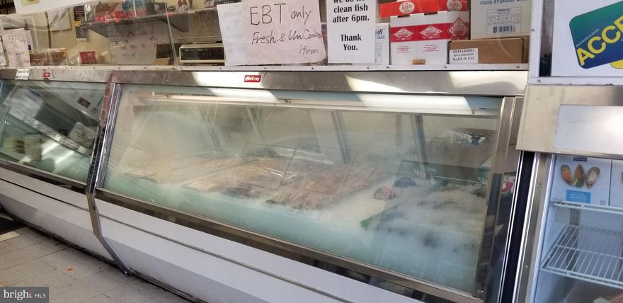 This is a very busy corner building on a main street, and it's been a seafood restaurant for a very long time, and it used to do extremely well. The current tenant has a 20-year lease, starting at $2,560 per month, with a $50 increase every year starting from the third year. This restaurant has had very high sales for a long time. It has a walk-in freezer, cooking grills, and all the necessary equipment. The current owner is currently renovating the facilities. The next owner will receive monthly rent payments. This is a very good investment property. The building owner is only responsible for property taxes, building insurance, and roofing; the tenant is responsible for everything else. The tenant will likely pay the rent reliably because they expect to receive over $150,000 when they eventually sell the business.