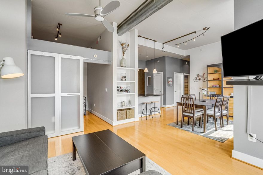 Welcome to Carlyle Square, a stunning top-level 1BR + Den, 1BA condo that blends industrial style with modern comfort. Soaring 11-foot ceilings, exposed ductwork, and an open layout create a spacious, loft-like feel, while the full-length private balcony offers seamless indoor-outdoor living. The versatile den is perfect for a home office or guest space. Enjoy a beautifully landscaped, secure courtyard, with optional membership access to a pool and fitness center. Step outside and immerse yourself in vibrant Carlyle living—just steps from cafés, restaurants, shops, and parks. With the King Street Metro only 0.3 miles away, commuting and exploring Old Town Alexandria and D.C. has never been easier.