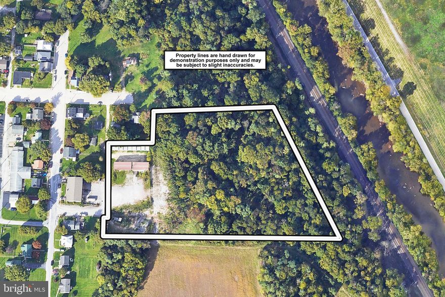 This versatile commercial mini-warehouse complex presents a rare opportunity for investors seeking stable income with strong upside potential. The property features a total of 31 drive-up self-storage units ranging in size from approximately 12'x20' to 14'x24', offering flexible options for renters and consistent cash flow. Additionally, two large warehouse units, each approximately 1,200 sq ft, are equipped with loading docks and drive-in ramp doors—one of which has been recently upgraded with a new edge-of-dock leveler—making them ideal for small businesses or contractors in need of secure workspace and access. Complementing the commercial spaces are two single-family homes on-site, both of which are tenant-occupied and contribute to the monthly rental income. The property also includes 1.5 acres of newly revamped outdoor storage space—graded, cleaned, and now actively being marketed for lease—perfect for RV, trailer, or contractor equipment storage. Current monthly rental income stands at $8,927, with four storage units still available for lease, and several long-term tenants still paying below market rates, offering immediate opportunities to increase revenue. The entire tenant base is managed through an electronic payment software system, streamlining collections and eliminating the need to handle cash or checks. Since ownership, major capital improvements have been made including new roofing, gutters, and modernization of leases and tenant management systems. The property is zoned Commercial – Mini Warehouse and also includes over 5 acres of additional wooded, commercially zoned land that adds to its long-term value. Operating at a 7% cap rate based on current income—with rising rents and continued lease-up efforts underway—this asset is well-positioned for further financial growth. The owner’s responsibilities are minimal, limited to real estate taxes, exterior lighting, and landscaping for the lower lot, making this a low-maintenance, high-yield investment. Whether you're an experienced investor or expanding your portfolio, this property offers multiple income streams, quality improvements, and a strong foundation for long-term returns.