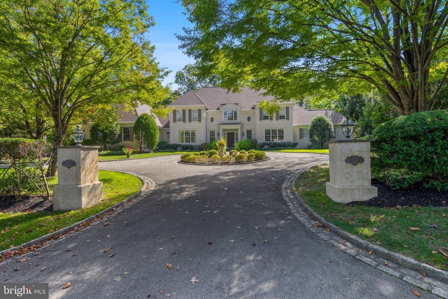 Located on one of Bryn Mawr’s most prestigious streets, 923 Waverly Road offers timeless craftsmanship, generous scale, and a beautiful one-acre lot in the award-winning Lower Merion School District. Built in 2000 by Cassella Builders, a respected Main Line custom builder known for craftsmanship, this French Colonial features 4 bedrooms, 3 full baths, and 2 half baths, plus a second-floor sitting room/den that could serve as an additional bedroom. High ceilings, hardwood floors, custom millwork, and sun-filled rooms provide elegance and comfort for everyday living and entertaining.
The approach sets the tone: lighted stone pillars mark the entry and open to a circular front drive that creates a gracious arrival. Inside, the two-story foyer with sweeping double staircase and marble flooring makes a dramatic introduction. From here, your eye is drawn straight through the great room’s French doors with views of the rear yard. To the right, a large office with built-in cabinetry serves as a work-from-home space or a more intimate setting for relaxing. To the left, a formal dining room connects to a butler’s pantry with wet bar and storage. A walk-in pantry is also in this area, flowing into the adjoining kitchen.
The kitchen, designed for both function and flow, features Kountry Kraft cabinetry, fresh white paint (2025), new quartz countertops (2025), a center island with seating for four, and a new Dacor refrigerator. With sightlines to the rear yard, breakfast room, and two-story great room, it is filled with natural light. The breakfast room includes a wet bar and French doors to the slate patio. Custom millwork defines the transition between the breakfast room and great room, maintaining openness while adding architectural character.
At the heart of the home, the two-story great room offers dramatic scale with a wall of windows and French doors to the slate patio. Built-in cabinetry frames the gas fireplace, while multiple seating areas provide space for gatherings and quiet evenings. Additional conveniences on the main level include a mudroom with garage access, laundry with new washer and dryer (2025), and two powder rooms.
The right wing of the main level hosts the primary suite, which includes a private sitting room and a large ensuite bath with dual vanities, walk-in shower, and soaking tub. Two walk-in closets are positioned off the bath, both with built-in shelving, and one includes a safe. This wing provides flexibility as the primary suite or as a guest suite.
Upstairs, the right wing includes a bedroom, hall bath, and a sitting room/den—creating a second suite option or could be used as two bedrooms with a hall bath. The left wing offers two large bedrooms connected by a Jack and Jill bath, which features a separate dual-vanity room, a full bath with tub, and a walk-in shower. A cedar walk-in closet is also part of this suite, in addition to a linen closet in the hallway.
The lower level, unfinished yet expansive with high ceilings, offers potential for future living space and could accommodate a golf simulator.
The rear yard is a private oasis with specimen trees, beautiful landscaping, and a newly installed black wrought-iron fence. A slate patio with a built-in gas grill offers multiple areas for outdoor dining and entertaining. A three-car side-entry garage and a second entry door to the mudroom complete the setting. Recent updates include a new roof and gutters (2025).
Ideally situated just .6 miles from the Village of Gladwyne with its market, pharmacy, and McCaffrey’s Food Market, and 2 miles from Bryn Mawr’s shops, dining, and train station with service to Philadelphia and NYC. Suburban Square in Ardmore is 3 miles away. Center City is an easy commute by train or car, while Saunders Woods Preserve just around the corner (.2 miles) provides walking trails. The home is also convenient to local country clubs and top-rated private schools, and is served by the highly ranked Lower Merion School Distric