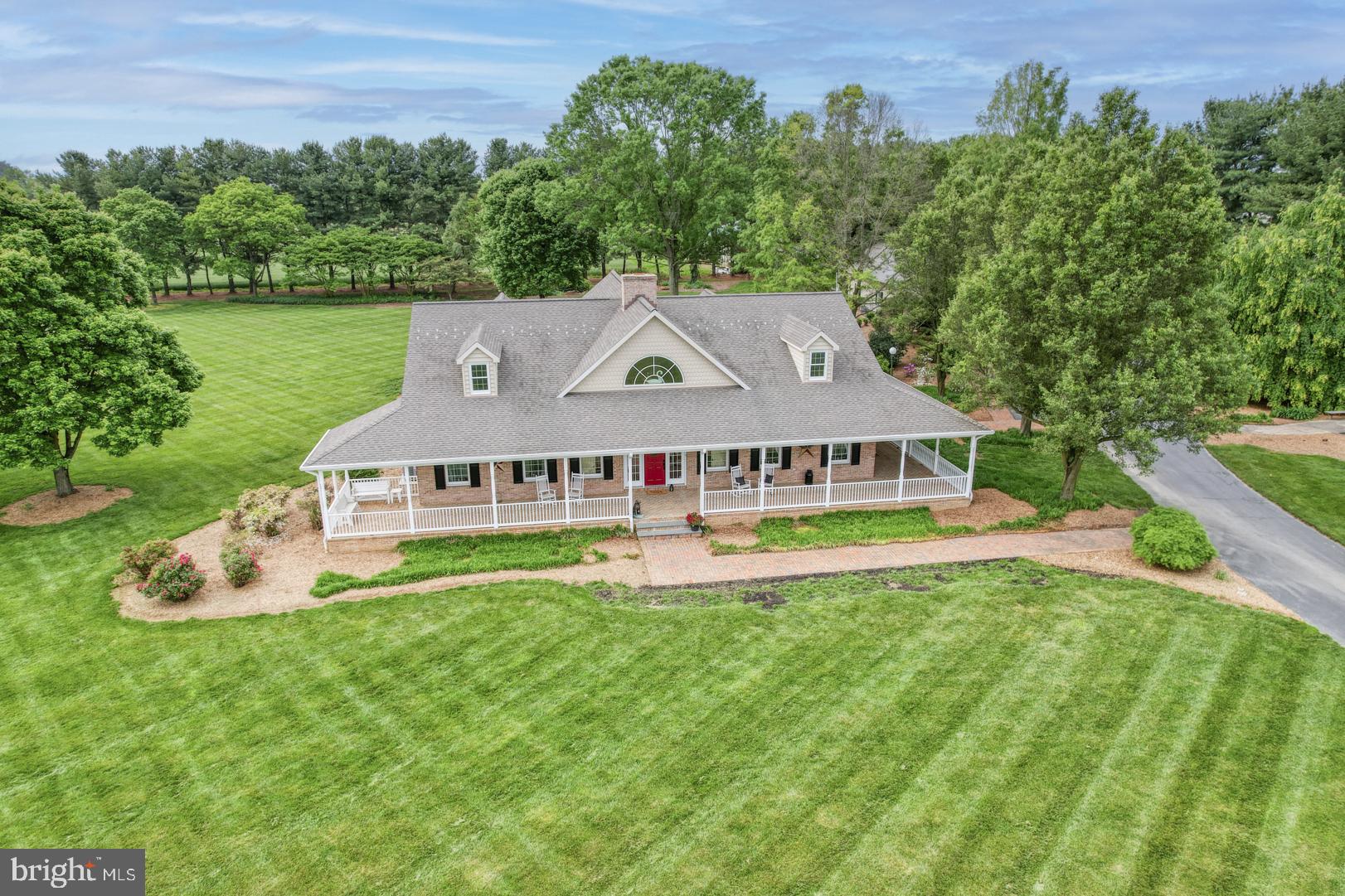 Nestled on 20+ acres of picturesque landscapes, this luxurious 4-bedroom, 4-bathroom home is a serene oasis just minutes from the convenience of 301 and the tax-free delights of Delaware. A private entrance, brick pathway, and beautifully manicured grounds create a sense of seclusion and privacy, inviting you to escape the hustle and bustle of everyday life.
Upon entering this stunning home, you are immediately struck by the soaring 18-foot ceilings and inviting brick fireplace, surrounded by rich cherry hardwood floors that exude warmth and sophistication. The great room is bright and open, effortlessly flowing into the gourmet kitchen, which boasts granite countertops and custom backsplashes that showcase the homeowner's attention to detail.
The kitchen is a true showstopper, with ample counter space, premium appliances, and a built-in brick grilling area that's perfect for entertaining. The sunny backyard is an extension of the indoor living space, offering a peaceful retreat to relax and unwind.
Each of the four bedrooms is a serene sanctuary, with generous closet space and ensuites that are sure to impress. The master bedroom is a true retreat, with a spa-like bathroom, extended sitting room with fireplace and a private patio with breathtaking views of the surrounding landscape.
Other notable features of this exceptional home include a convenient mudroom, a spacious laundry room, and a two-car garage that provides ample storage space.
In addition to its picturesque surroundings, the home also features an impressive 1800 sf garage, complete with a cedar room, office, and bathroom. The garage offers ample storage space and is perfect for hobbies, workshops, or simply storing your toys.
But the true gem of this property is its location. Surrounded by state land and private farms, this farm offers a sense of seclusion and privacy that is hard to find in today's fast-paced world. And with open space stretching as far as the eye can see, the possibilities for outdoor adventure and exploration are endless.
Don't miss out on the opportunity to make this incredible property your own. Schedule an appointment and experience the beauty and tranquility of this country farm for yourself. Whether you're looking for a peaceful retreat or a place to pursue your passions, this property is sure to impress.