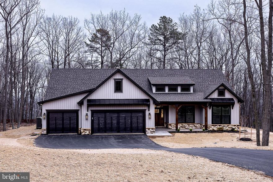 TO BE BUILT!  Ready February 2025 - You can still pick out your cabinets, flooring and countertops if you hurry! Welcome home to the Greenbrier, the newest Signature Series floorplan designed by Panhandle Homes of Berkeley County.  This home features over 2,200 square feet of living space PLUS over 800 sq ft of garage space!   Have you ever dreamed of a HIDDEN pantry or a GOURMET kitchen?  This home has both!! 4 bedrooms and 2.5 bathrooms offers plenty of space.  The Owners Suite has a huge bathroom with a Full Ceramic Tile Wet Room with a Freestanding tub and large tiled shower area!! A mudroom, media closet and powder room are both right off of the garage/entry foyer.  The oversized laundry room is perfectly placed outside of the Owners Suite and comes with a sink.  The Great Room will wow you with its cathedral ceilings and fireplace, perfect for those cool evenings.  Located on top of the mountain, this home has a 18' x 14 ' covered rear porch which is great for enjoying the serene slice of nature that this incredible lot provides!  This lot is eligible for a Class A Membership, which offers incredible amenities such as indoor/outdoor pools, spa, sauna, fitness center, golf courses, tennis and more!
Pictures are of this same floorplan which is under construction, on a different lot.