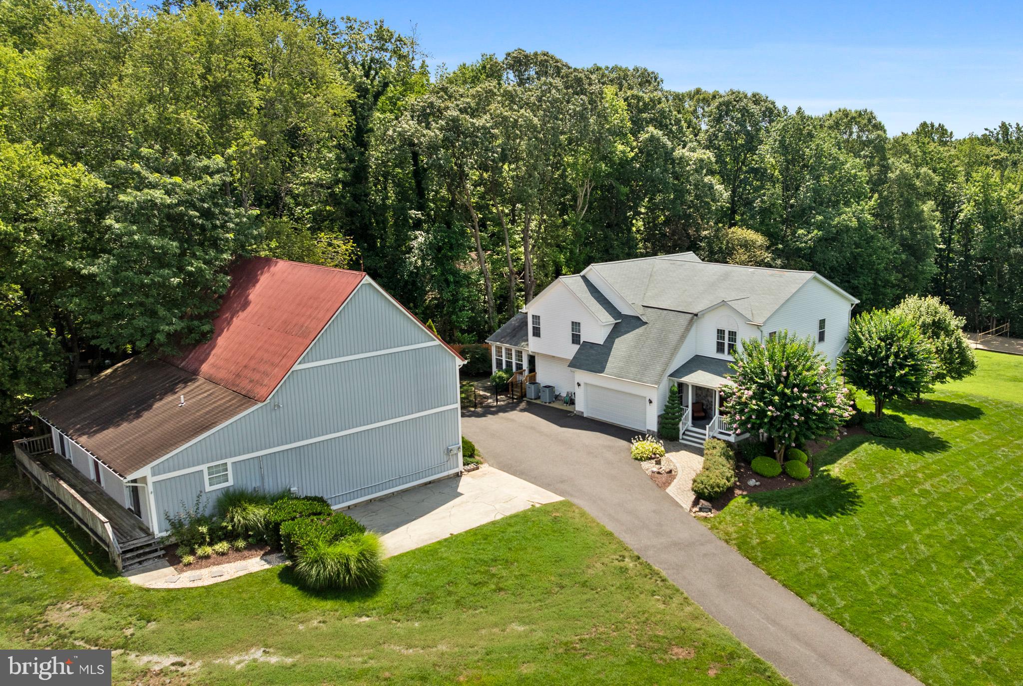 Welcome home to this magnificent over 6000 sq ft beauty in the sought-after Dunkirk location! Make your way up the driveway soaking in the desirable curb appeal with a well-manicured, usable lawn with extensive landscaping, gorgeous stone siding, and welcoming front porch. Enter the front door to gleaming engineered hardwood flooring (just installed in 2023) throughout the entire main level! Foyer opens into spacious great room with recessed lighting, crown molding, attached dining nook, and door off great room leading to back porch with steps down to stunning fenced-in, in ground pool area. Gourmet kitchen boasts 42’ cherry cabinets, granite countertops, walk-in pantry, updated stainless steel appliances, kitchen island, recessed lighting, ceiling fan, and powder room off kitchen. Kitchen overlooks second family room which could also be used a formal dining room, morning room, library… the possibilities are endless! Step out onto the balcony off the kitchen, seamlessly connecting you to the spacious sunroom with mini split system for year-round use, TONS of windows and views of your side yard and fenced in pool area… perfect for morning coffee or evening relaxation. Upstairs boasts HUGE primary bedroom suite with sitting area and primary bathroom attached with his & hers sinks, soaking tub, oversized shower, and walk-in closet. Second primary bedroom (bedroom #2) has closet space galore!! One walk-in closet, and an additional walk-in closet that could be used as an office/nursery… Bathroom also attached with soaking tub and separate shower. Bedroom #3 bedroom #4 were opened up to become one large bedroom but could easily be converted to 2 separate bedrooms (window in each room and separate closets). Bring the party downstairs to the fully finished basement with a custom wet bar with granite counters, beverage fridge, ice maker… open rec room, large gym area, pellet stove, and bathroom! Walk out from the basement to your backyard oasis… Heated, inground, gunite pool in it’s own fenced in enclosure… tons of hardscaping and landscaping! But wait… there’s more! Detached barn with additional garage, storage area, finished area currently being used as a home office with mini split, PLUS attached apartment with 1 bedroom, living room, kitchen, washer and dryer, and full bathroom. Perfect to use for your liking, or to rent out for additional income! This home is the epitome of comfort, luxury, and functionality. Don’t miss your opportunity to own a piece of paradise in Dunkirk, just minutes away from the Patuxent River. Schedule your showing today!