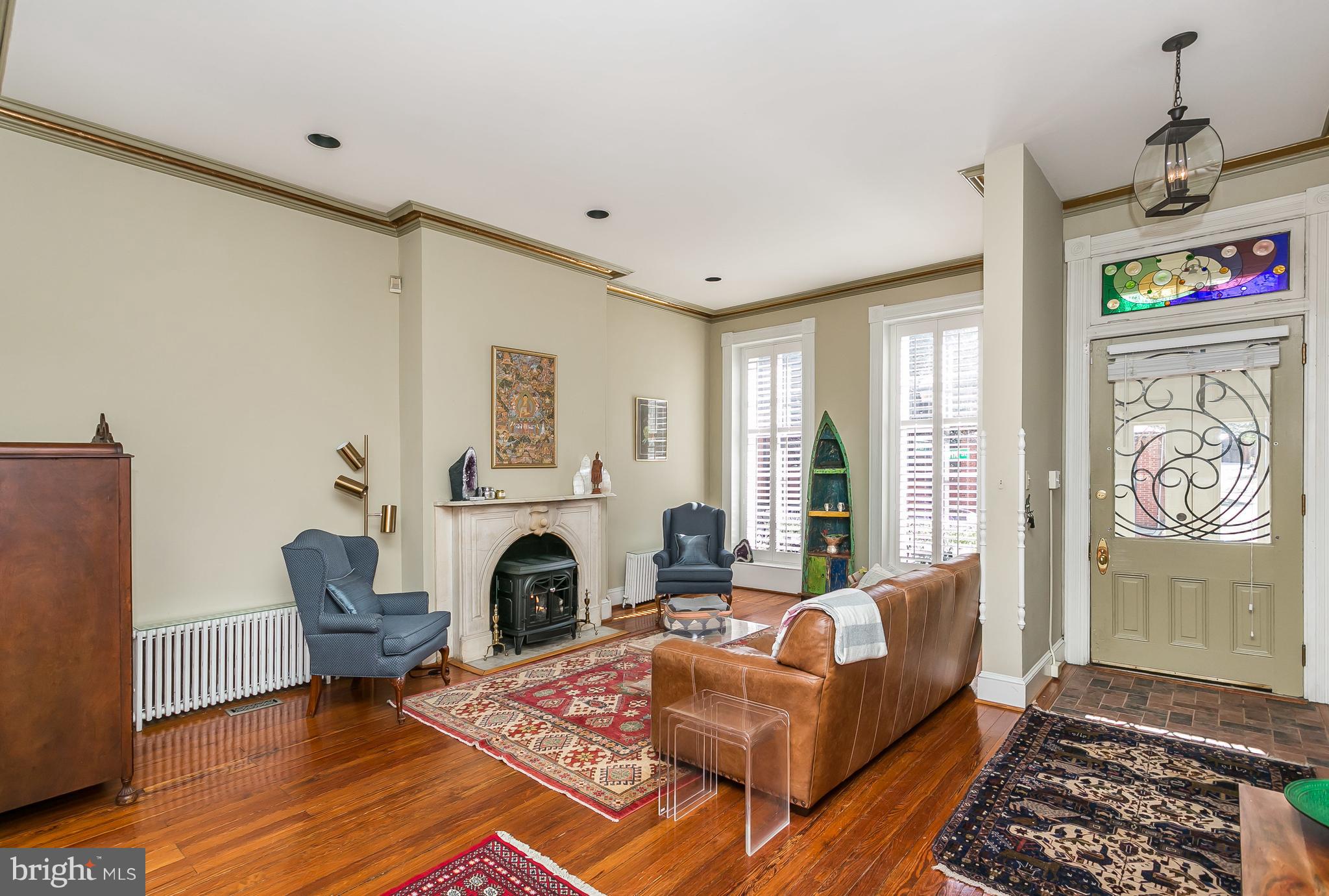 Picturesque and Light Filled, End of Group Townhouse overlooking the coveted John Street Park in Historic Bolton Hill. This is a non-thru street with a beautiful serene fountain and benches to enjoy all year long. The house has 4-5 Bedrooms, 4.5 Baths, Finished Lower Level Family Room, Au-pair or In-Law Suite in Lower Level, 2 Master Bedroom Suites, Renovated Kitchen, Updated Baths, Wood Floors, Original Details including Beautiful Mantels and Moldings, Gas Fireplace in Living Room, Wood Burning Fireplace in Kitchen, Plantation Shutters, Private Deck overlooking a lovely Walled Brick Courtyard and Garden for your Urban Oasis. Zoned Central AC, 4 Zones of Gas Heat. Convenient to Penn Station, MARC Train to DC, AMTRAK, Light Rail, Subway, Hopkins Shuttle, MICA, Cafes, Restaurants and everything to Penn Station, MICA. Baltimore has to offer. Ample Street Parking. Subject to the Midtown Benefits District Surcharge Tax.