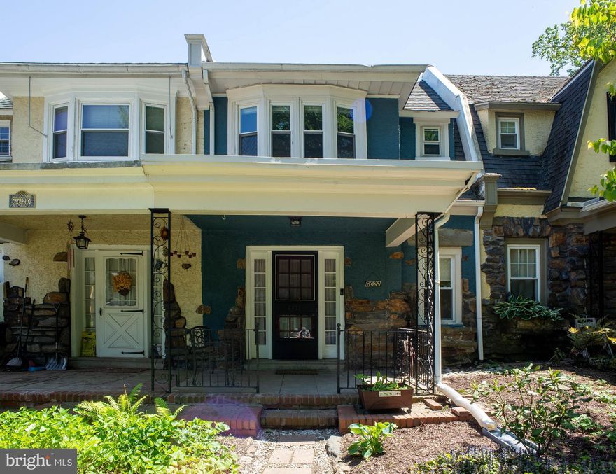 On a secluded & highly-desirable block, this charming & well-cared-for Overbrook Farms rowhome still contains some original details alongside modern upgrades. **In the last year, the owners applied a new silver coating to the roof, remediated knob & tube wiring throughout the home and installed a new stack.** Two sizable garden beds at the front of the home lead by a brick paver walkway to the covered front porch, a perfect place to relax in the shade and listen to the birds in nearby Morris Park. On the first floor, the cozy living room receives lovely indirect light thanks to a row of windows, and has both a fireplace and built-in shelving. It leads into the dining room and open kitchen with newer stainless appliances (dishwasher, gas range with a dual-oven option, and fridge). Through the kitchen is a full bathroom with stall shower. A large rear deck is located right off the dining area. On the second floor you'll find three bedrooms and another full bath with tub & shower. The walk-out basement leads to the parking pad and single-car garage; washer, dryer, and utility sink are located in the basement as well.  Close to the light rail, Overbrook SEPTA station, Penn and Drexel campuses, plus restaurants & shopping and mere steps to the trails of Morris Park, this home is ideally located AND is within the qualifying area the Closing Cost Reduction Program for UPenn Employees! Schedule your showing today!