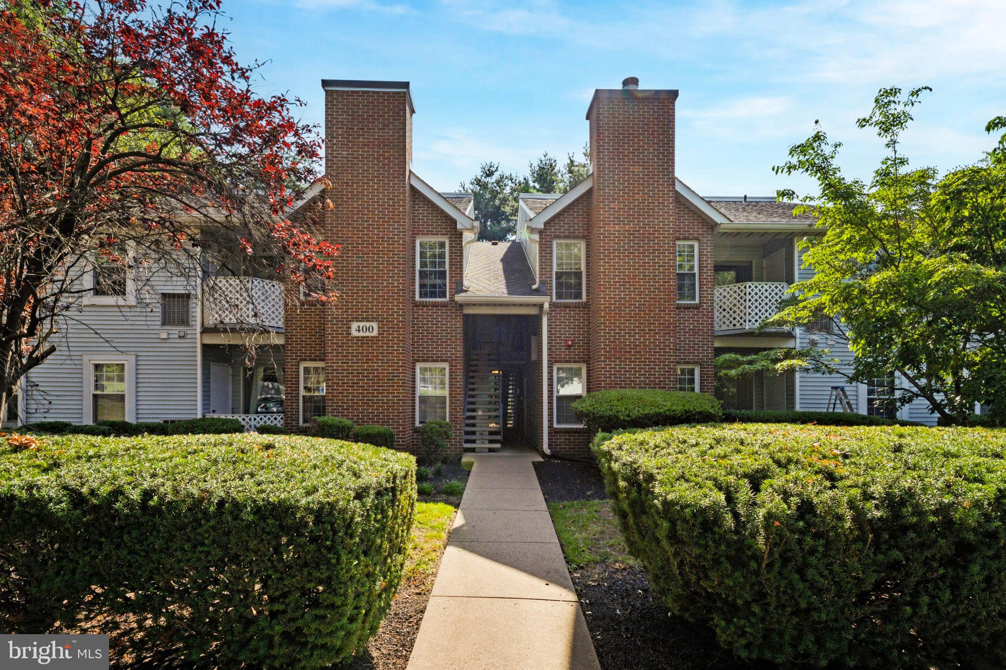OPEN HOUSES THIS SATURDAY (8/2) & SUNDAY (8/3) FROM 1-3PM! Welcome to 407 Diamond Drive, a meticulously maintained 2-bedroom, 2-bath condo in the highly desirable Crown Pointe community of Newtown, Pennsylvania. This first-floor unit combines smart upgrades with everyday practicality, creating a space that feels both fresh and timeless. Inside, the layout flows effortlessly from room to room, starting with a bright living area framed by large windows that bring in natural light and offer peaceful views of mature trees. Just off the living room is a private covered patio, perfect for relaxing, with a convenient outdoor storage closet for seasonal gear or extras. The kitchen has been thoughtfully updated with crisp white cabinetry, stainless steel appliances, a gas range, and a stylish tile backsplash. A center island adds function and charm, offering additional prep space and seating. The adjacent dining room comfortably accommodates a full-size table and a picture window overlooks the patio and rear property. One of the most appealing features of this home is the reconfigured primary suite. The ensuite bathroom has been smartly redesigned as you can see in the photography, and the addition of a custom closet adds a level of luxury and organization rarely found in similar units. The primary bedroom is spacious and modern, with a large walk-in closet. The second bedroom is equally bright and versatile, ideal as a guest room, home office, or nursery. A second full bathroom with tub shower sits nearby, along with a dedicated laundry room tucked out of sight for maximum convenience. What truly sets this property apart is its location within the Crown Pointe community. Just steps from your door, you'll find a well-maintained in-ground swimming pool with a clubhouse, tennis courts, and a playground. These amenities are not just marketing fluff; they're actually usable, well kept, and close enough to make part of your daily routine. Situated in the heart of Newtown, a quintessential Bucks County town known for its colonial charm, top-rated Council Rock schools, and lively downtown, this condo offers more than just a comfortable home; it’s a complete lifestyle. Commuters will appreciate easy access to I-95, Route 1, and the PA Turnpike, making Philadelphia, Princeton, and even New York City feasible options for work or play. Whether you're a first-time buyer, downsizer, or investor, 407 Diamond Drive stands out as a smart, move-in ready opportunity in one of the region’s most sought-after zip codes.