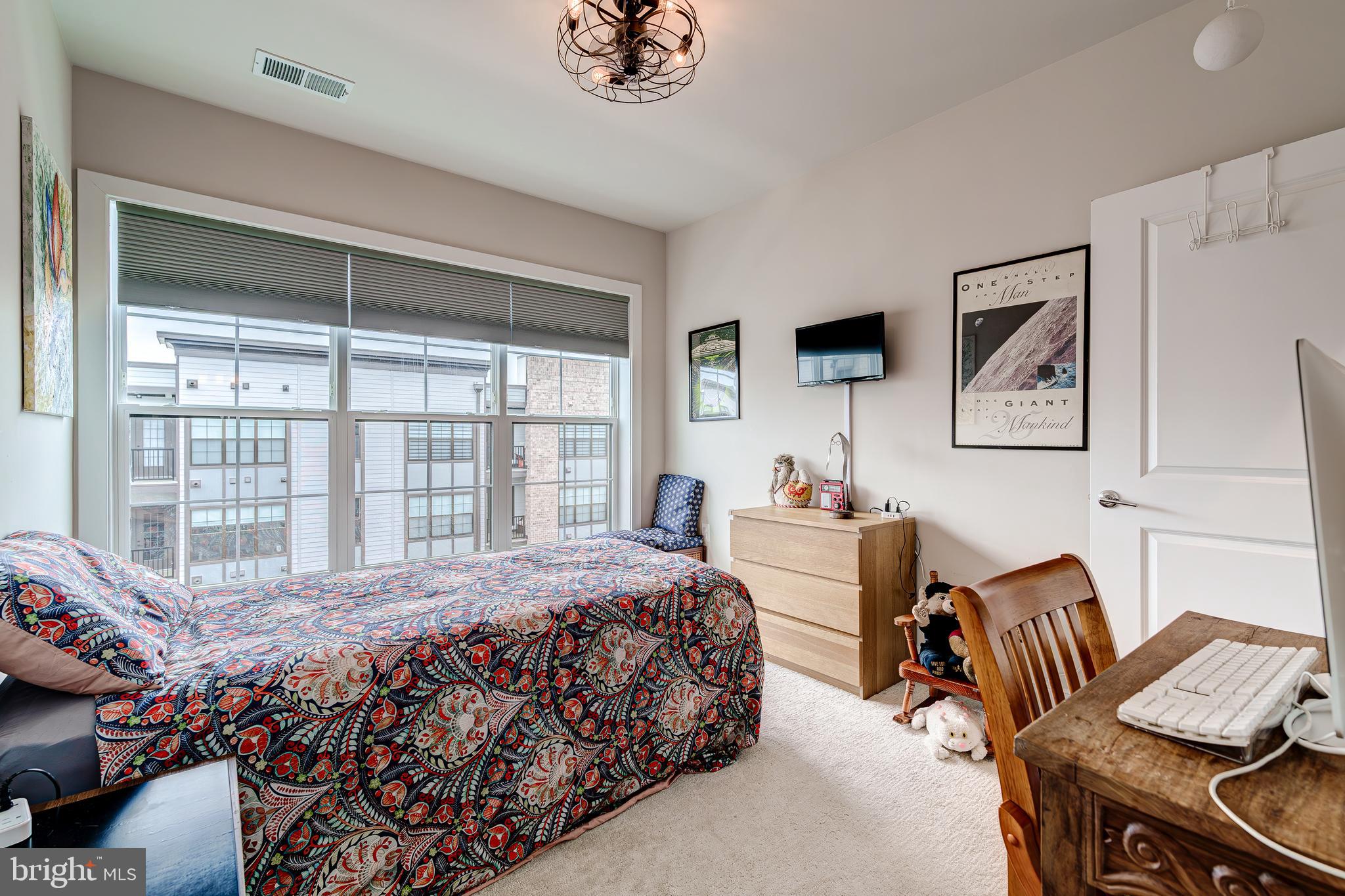 Owner is eager to start retired life on a beach!Price Adjustment!
Check out this gem located in the gated community of The Flats at National Harbor. This coveted top-floor unit (with partial views of the Harbor’s marina features 2 bedrooms, 2 bathrooms, and a versatile den that shows like new. Only 2 years young, this home is brimming with premium upgrades such as an inline hot water softener on the tankless water heater, pedestal Whirlpool washer and dryer, ceiling fans in 5 areas, and custom, cordless blackout blinds throughout. As you enter, an open and inviting space greets you. The kitchen boasts gleaming white cabinetry, quartz countertops, a tile backsplash, a 5-burner stove, a wall-mounted oven, and a motion-sensing kitchen faucet. Imagine preparing your favorite dishes in this well-appointed space, with the living room providing the perfect backdrop for engaging with friends and family. Next to the kitchen, there's a large den that can be used as an office, playroom, extra living space, or fitness room. With French doors and beautiful privacy-enhanced glass, you can transform this space as far as your imagination takes you. The primary bedroom features a large ensuite bathroom and a spacious walk-in closet. The second bedroom offers ample closet space and is conveniently situated next to a full bathroom in the hallway. A spacious laundry room houses upgraded front-load washer and dryer units. This home includes one assigned garage parking space with bike rack. Residents can also enjoy beautifully landscaped common areas and controlled entry access for guest and one assigned parking space in the covered garage!Residents benefit from discounts at restaurants, shopping, dining, and parking at National Harbor as well as easy access to bike and walking trails. The community is conveniently close to Andrews, Bolling, the Pentagon, and Old Town Alexandria, with easy access to 495/95, 295, and just minutes from downtown DC. The MGM and Tangier outlets are less than 5 minutes away.