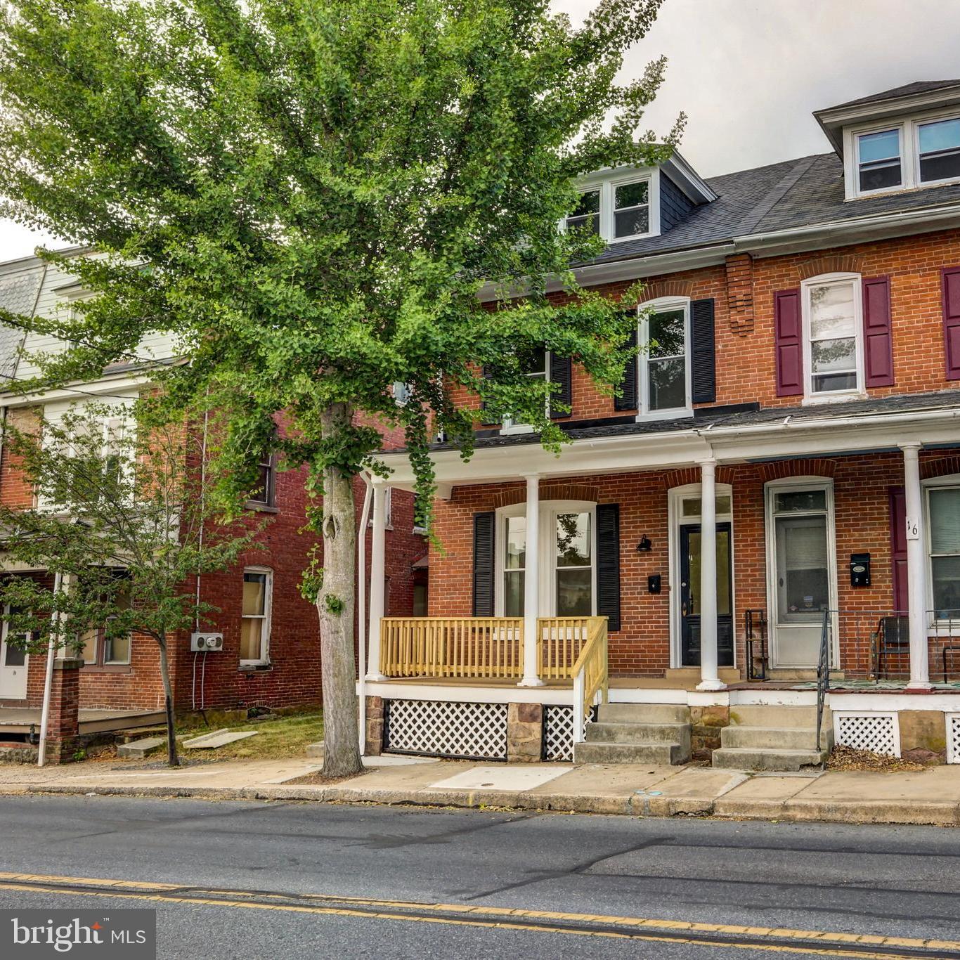Welcome to 14 N 6th Street - this beautiful, brick semi-detached home has been fully remodeled and updated all while preserving its classic charm! Before entering the home you'll notice the welcoming front porch paired with striking white pillars. Once inside, you're greeted with a bright and open space, HIGH ceilings, glowing, original hardwoods, and tall windows. Past the living area is a spacious separate dining room, perfect for hosting gatherings. The kitchen is equally generous on space, complete with stainless steel appliances, upgraded quartz countertops, and stylish white cabinets. A brand new half bathroom and laundry room has also been conveniently added right off the kitchen as well. The rear of the home offers a mud/storage room that leads to a fenced in backyard along with two off street parking spots. Up to the second floor, you'll find three well-sized, bright bedrooms and full bathroom which features a lovely tiled tub, luxury vinyl plank flooring, and a new, modern vanity/fixtures. The attic on the 3rd floor along with the partially finished basement allows for plenty of storage and recreation space as well. Enjoy the home without concern for maintenance thanks to a new roof, new windows, new efficient gas furnace/water heater, and all mechanicals updated to code. This home is in a great location, located on quiet street but only a short drive to access Rt. 272, 222 and the PA Turnpike. Vacant and easy to show - contact us today!