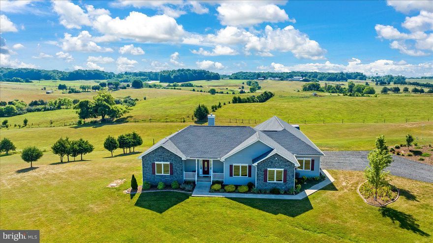 Located on 10 gorgeous open acres in Culpeper County, this custom-built rambler offers the perfect blend of craftsmanship, convenience, and country serenity. From every angle, the property showcases wide-open views and endless possibilities—ideal for gardening, livestock, or simply enjoying the peace and beauty of your own land. Outdoors, the features are exceptional. A 24' x 32' pole barn constructed in 2021 includes 15-amp solar power and a large machine overhang, ready for farm equipment, hobby space, or storage. The rear and side perimeter of the property are fully fenced, making it a great fit for animals. The oversized three-car garage includes built-in workbenches, offering a true handyman or woodworker’s dream setup, while a 10’ x 12’ storage shed (added in 2019) provides even more utility. A covered rear porch offers the perfect place to unwind and take in the quiet views of the surrounding acreage. Inside, this thoughtfully designed home spans one level with a split-bedroom floor plan that includes three bedrooms and two baths. The incredible owner’s suite feels like its own private wing, complete with a large walk-in closet, a laundry area within the suite itself, and a spa-like bath featuring an oversized tiled shower and soaking tub. The main living area is light-filled and open, with vaulted ceilings in the family room and durable LVP flooring throughout. The kitchen is a showpiece, showcasing custom cabinetry, quartz countertops, a custom metal backsplash, black appliances, and LED under-cabinet lighting that accentuates every detail. This property has been exceptionally maintained and upgraded. The roof, windows, and hot water heater are original from the new build in 2019, and the HVAC and heat pump were updated in 2025. Additional renovations include wainscoting in both bathrooms, the dining room, and one wall in the great room; fresh interior paint; a whole-house water filtration system; and two whole-house surge protectors added in 2021. Professional landscaping enhances the home’s curb appeal, while new touches throughout ensure truly move-in-ready living. Located just minutes from shopping, dining, and all main thoroughfares, this property offers the best of both worlds—rural tranquility and modern convenience. With 10 beautiful acres, a spacious pole barn, a dream garage, and a stunning custom home, this Culpeper retreat delivers country living at its most comfortable and refined.