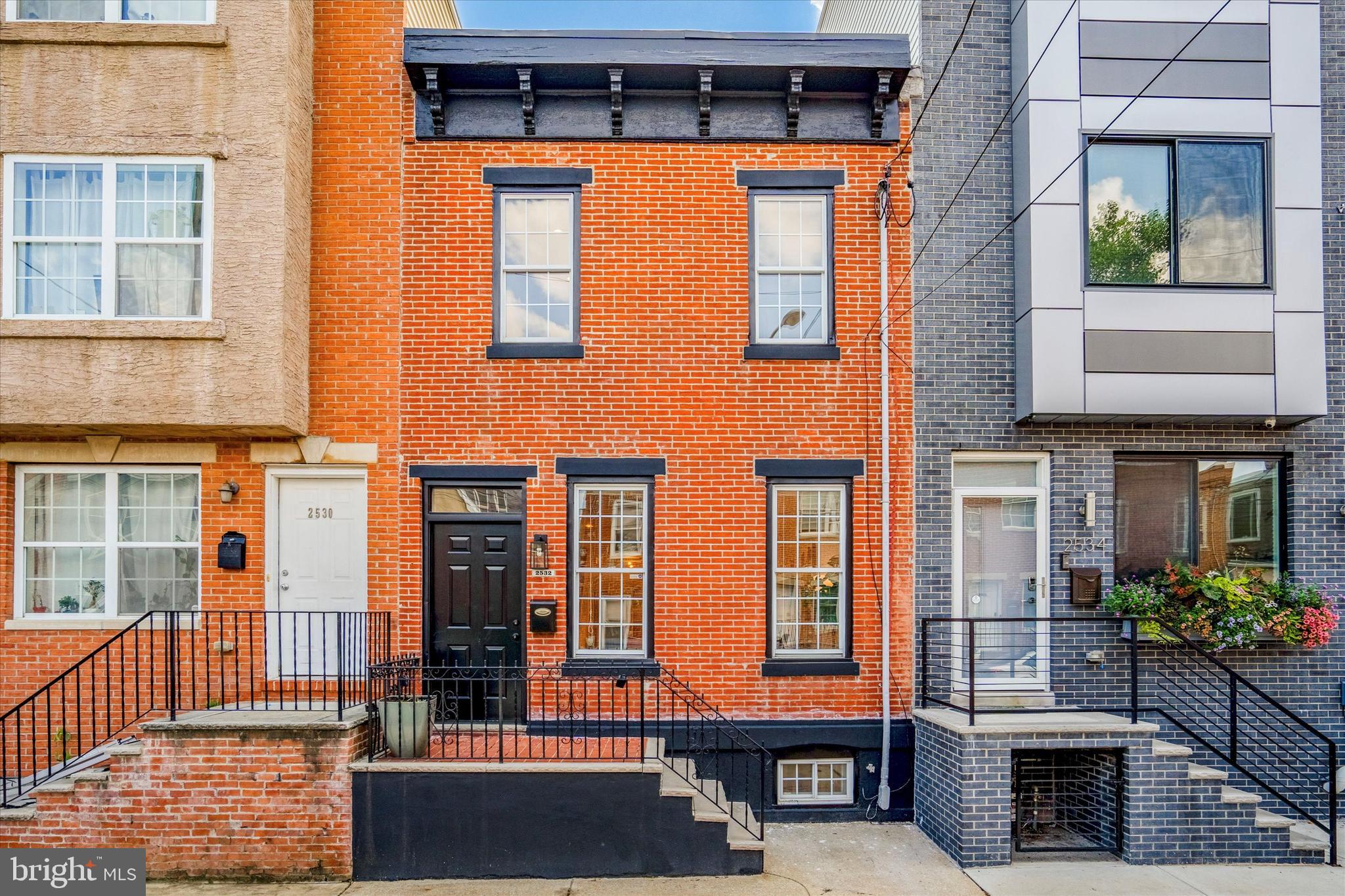 Gorgeous totally renovated inside & out classic Red brick & modern Black exterior 3 bedroom, 1.5 bath home with a wide open first floor living room, dining room & cooks’ kitchen that open up to the large private rear yard & patio, an additional family/kids/pets room, laundry/fitness/office room & utility/storage room on the finished lower level & a bonus 2nd floor rear deck in desirable Point Breeze with it’s restaurants, cafes, shops, pet stores, coffee & tea shops, brew & wine pubs, playgrounds & parks. With oversized & lots windows & tall ceilings this home gets great light throughout. It’s light & bright, open & airy & has great private outdoor space & one of the largest backyards in South Philadelphia. Updates include: eat-in cooks’ kitchen with a peninsula (White Solid Wood cabinetry, Quartzite stone countertops, brand new: Energy Star Samsung stainless steel “Smart appliances with WiFi & voice connectivity”: 5 burner gas range/convection oven, dishwasher, microwave & refrigerator/freezer, Brushed Brass cabinet hardware & light fixtures, Matte Black Kitchen Sprayer faucet, soap dispenser & AC/Heat vents, double bowl under mount stainless steel sink, White ceramic tile backsplash, recessed LED lighting). Primary full bath (Marble wall & floor tile, RainHead shower, whirlpool tub, Matte Black faucet, fixtures & mirror, Brushed Brass & recessed LED light fixtures & vanity hardware, White vanity, sink, countertop, toilet). Half bath (ceramic floor tile, Matte Black faucet & mirror, Brushed Brass LED light fixture & vanity hardware, White vanity, sink, countertop, toilet). The entire interior & exterior were just professionally painted (White inside, Black outside). All hardwood floors, stairs & hallways throughout were just professionally refinished. High Efficiency gas heat & central air systems (Tempstar), programmable thermostat, new roof, electrical panel with circuit breakers & wiring, outlets, light switches & lights, hot water heater (GE), washer & dryer (Hotpoint), Energy Efficient Low-E double hung windows, sliding glass & exterior doors, 6 panel interior doors with Matte Black door knobs & hinges, Matte Black wood railings/banisters, LED recessed lighting throughout the home, Smart home Matte Black “Dusk to Dawn” exterior glass lantern light fixtures (turn on & off automatically), Matte Black Exterior Wrought Iron front railings, mailbox, front steps, cornice, trim, walls, gate & rear deck, Red brick front stoop & rear backyard/patio steps. Features: lots of character, light, storage, windows & space inside & out. Deep window sills are great for plants & pets. The 2nd floor 3rd bedroom that leads to the rear deck is currently being used as an office. Backyard & rear deck great for entertaining, relaxing, pets, kids, your next BBQ or special occasion, growing Organic vegetables, herbs, plants, flowers in raised beds & containers. Great location, 1 block off of Washington Ave. Easy access to Target, Sprouts Market, Whole Foods, Trader Joes, Wharton Square Park & Playground, CHOP, UPENN, Drexel, University City, hospitals, Center City, The Navy Yard, Stadiums, 30th Street Train Station, Schuylkill River & Lanier Dog Parks, walk, run, hike & bike along the Schuylkill River Trail, Kelly Drive & Boathouse Row, Museums, Fairmount & Wissahickon Valley Parks, Philadelphia International Airport, 76, 676, 476, 95, PA suburbs, NJ, DE, Poconos, NJ/DE/MD beaches, Brooklyn & NYC. With the Philadelphia Homestead Exemption, the 2023 estimated property taxes would be lowered to $2230.