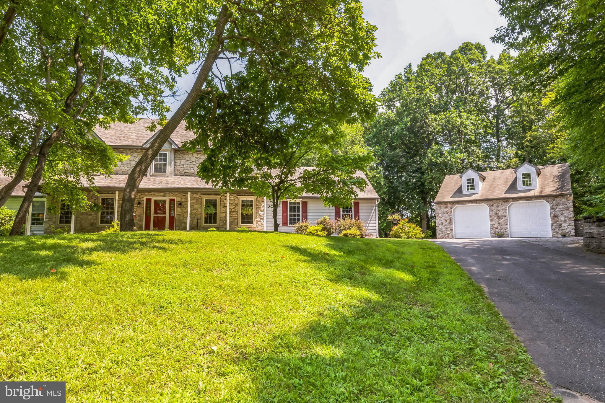 Welcome to this beautifully maintained, 3-bedroom, 2.5-bath colonial, perfectly situated at the end of a cul-de-sac on 2 acres in the highly desirable Owen J Roberts school district. From the moment you arrive, you'll be impressed with the mature trees and covered front porch, perfect for relaxing on your favorite chair. Head over to the oversized, detached 2 car garage with 11’6” high ceilings, a staircase to additional storage above and providing 1,425 sqft. for your extra rides, outdoor toys or workshop. The home features a desirable layout including a laundry/mudroom off of the attached 2 car garage. The formal dining room with wainscoting leads to the eat-in kitchen which has been tastefully remodeled in 2018 and has a large walk-in pantry. Continue out through the sliders to a welcoming composite deck (2024) and custom pergola offering beautiful views of Chester County. Whether you're hosting friends or enjoying a quiet night in, the spacious family room with new flooring and stone fireplace will be the perfect place to unwind. The main floor also includes a large office or it can be used as an additional bedroom. Heading upstairs you’ll find new carpeting taking you to 3 generously sized bedrooms, a full hall bath and a large primary ensuite bathroom with jacuzzi tub. The walkout basement gives 1,000 sqft of additional living space and is a great place to entertain with a one-of-a-kind custom bar and propane stove. In addition, the roof and propane heater were replaced in 2020. The rear yard of this beautiful home has open space and natural lush greenery for privacy, all in a convenient location. Don’t wait to make this lovingly cared for custom home yours!