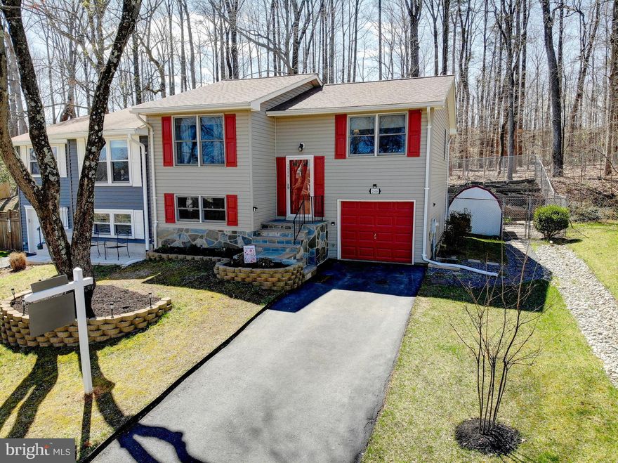 Welcome to 2606 April Dawn Way, a beautifully maintained semi-detached home nestled in a quiet setting in Gambrills, Maryland, located within the highly regarded Anne Arundel County Public Schools district and just a short walk to Four Seasons Elementary School—an especially convenient location for families. From the moment you arrive, the home’s curb appeal stands out with a newly refreshed asphalt driveway and elegant stone landscaping beds that frame the attractive flagstone front façade. Inside, the home features fresh paint on the upper level, newly installed luxury vinyl flooring, and brand-new carpet in the bedrooms, creating a bright and modern feel throughout.

The updated kitchen offers additional cabinetry and upgraded stainless steel appliances, providing excellent storage and functionality for both everyday living and entertaining. Outdoor living is where this home truly shines. A spacious deck overlooks the backyard and provides covered outdoor space for the paver stone patio below, which also includes a dedicated hardwired 240-volt circuit ready for a hot tub. Surrounded by mature trees and backing to woods, the backyard offers a private retreat that is perfect for relaxing evenings, entertaining guests, or enjoying your morning coffee just steps from the primary bedroom.

Over the years, the home has been carefully improved with numerous major updates, including a Lennox heat pump HVAC system, a new roof, a LeafFilter gutter protection system, updated and remodeled bathrooms, a replacement water heater, backyard hardscape patio improvements with electrical for outdoor use, and the addition of the front stone façade and enhanced landscaping. Additional features include a one-car garage, generous storage, and a functional split-foyer layout that provides comfortable living spaces on both levels. Located just minutes from shopping, dining, and major commuter routes—while still offering the tranquility of a wooded backyard setting—2606 April Dawn Way is a move-in-ready home that combines thoughtful updates, inviting outdoor spaces, and an exceptional location.
